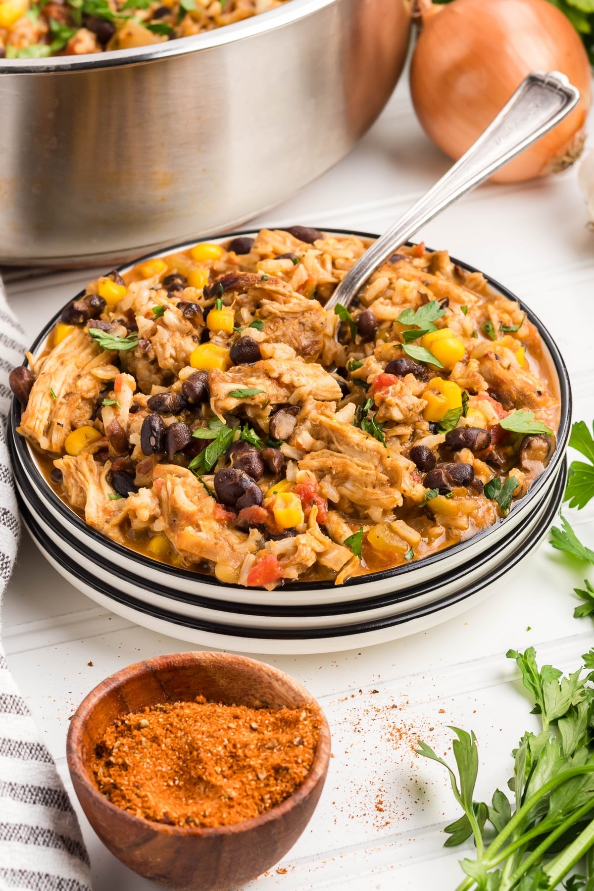Southwest Turkey Skillet portion served on a plate turkey skillet recipe on a stack of white plates.