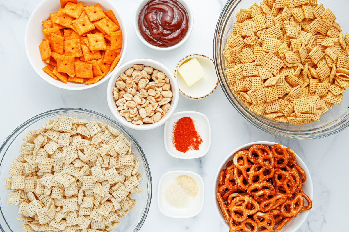 Ingredients for homemade BBQ Chex snack mix Ingredients for BBQ Chex snack mix including Rice Chex, Corn Chex, pretzels, Cheez-Its, peanuts and BBQ sauce