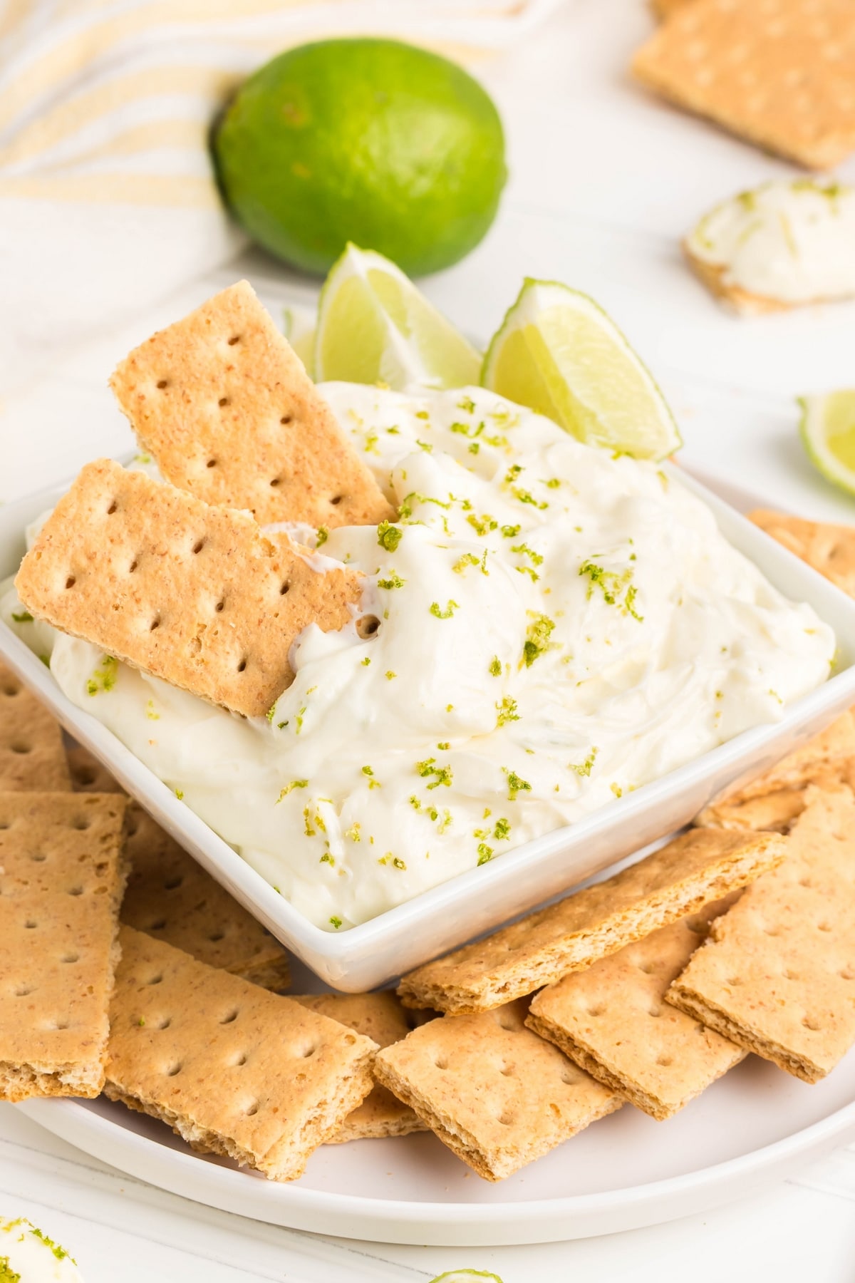 Key Lime Pie Dip served on a platter. Close-up of creamy key lime pie dip in a bowl with graham crackers.