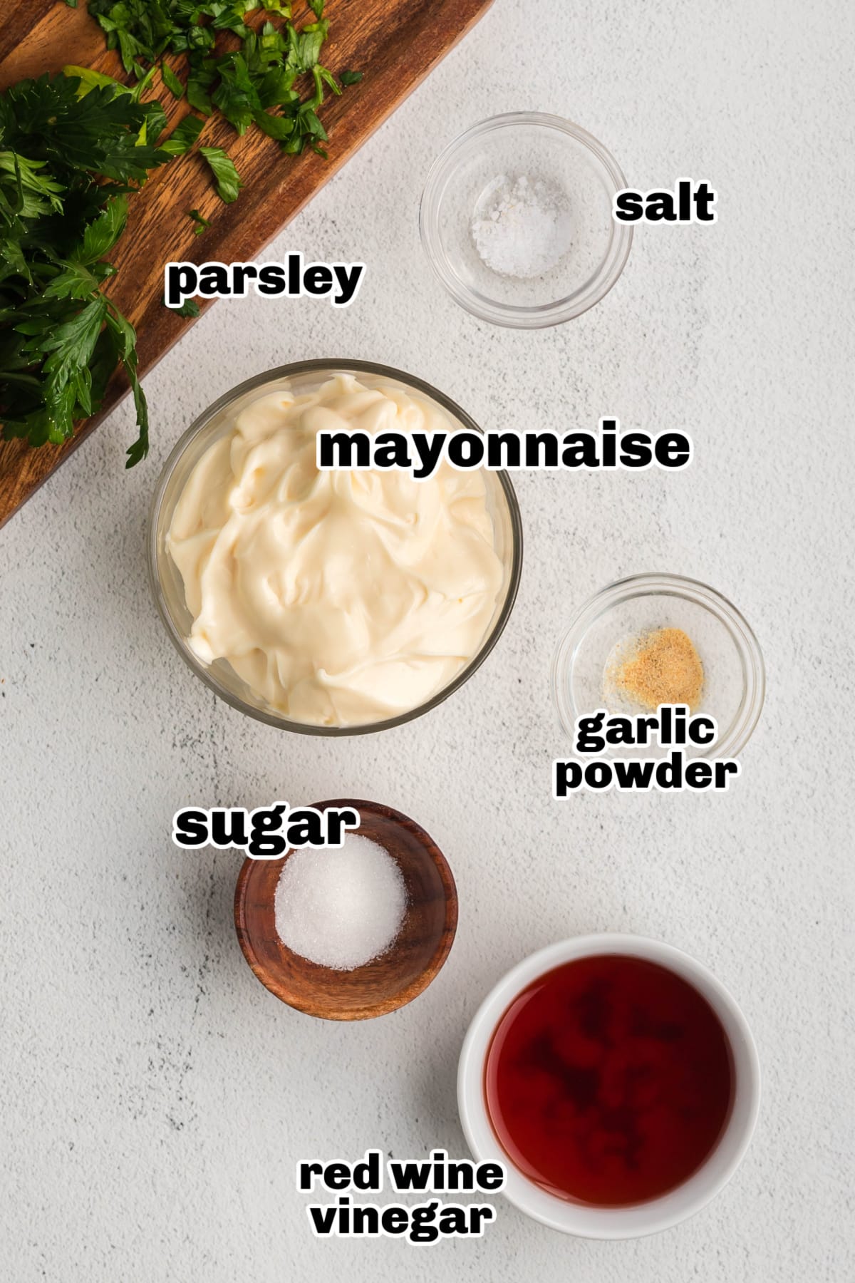 Ingredients for creamy mayonnaise salad dressing arranged on a countertop