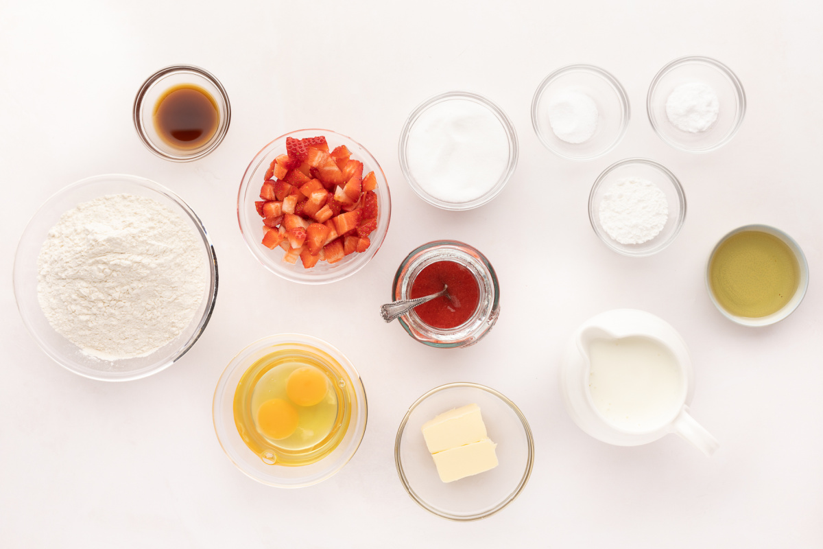 Fresh Strawberry Pancake Ingredients Ingredients for fresh strawberry pancakes including buttermilk, chopped strawberries, flour, eggs, butter, vanilla, and strawberry sauce.
