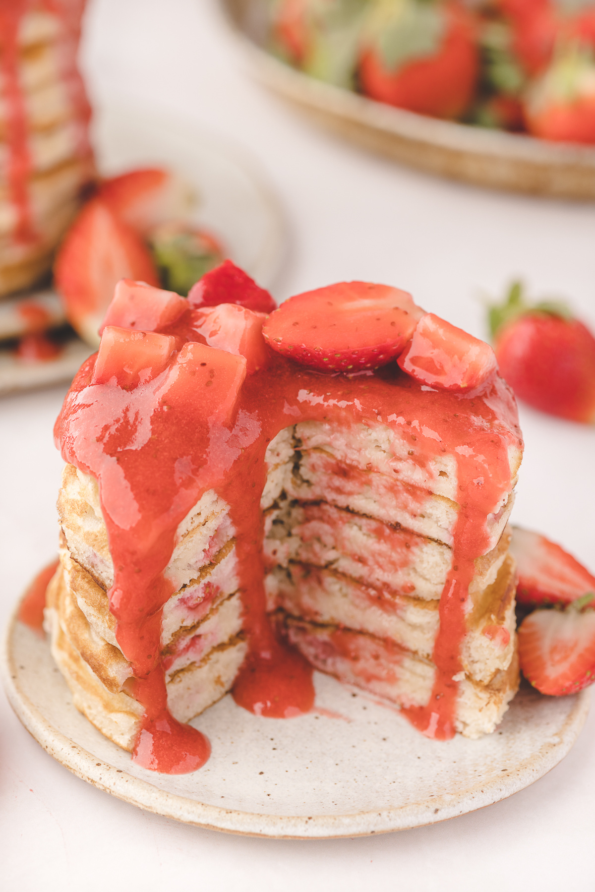 Fresh Strawberry Pancakes with Warm Strawberry Sauce Fresh strawberry pancakes stacked high with warm strawberry sauce dripping over the sides and jammy strawberries cooked into the buttermilk batter.