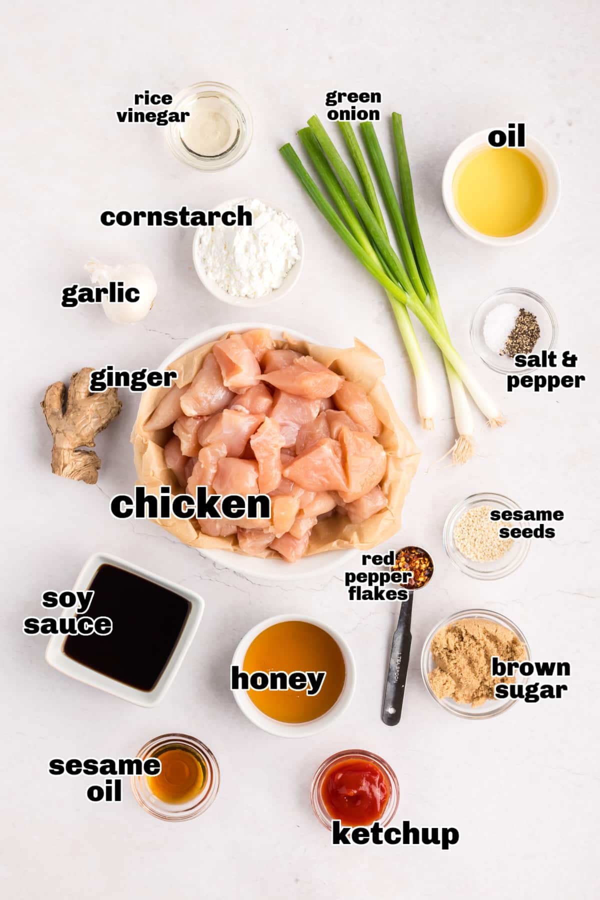 Overhead view of all the measured ingredients arranged on a counter, ready to make honey sesame chicken.