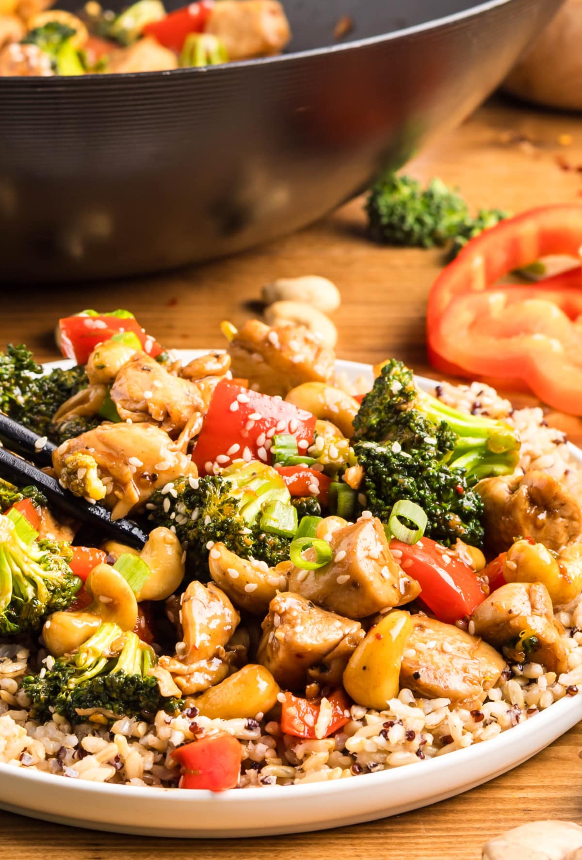 Sticky Cashew Chicken Stir-Fry with Wok in Background Close-up of sticky cashew chicken stir-fry with the wok in the background