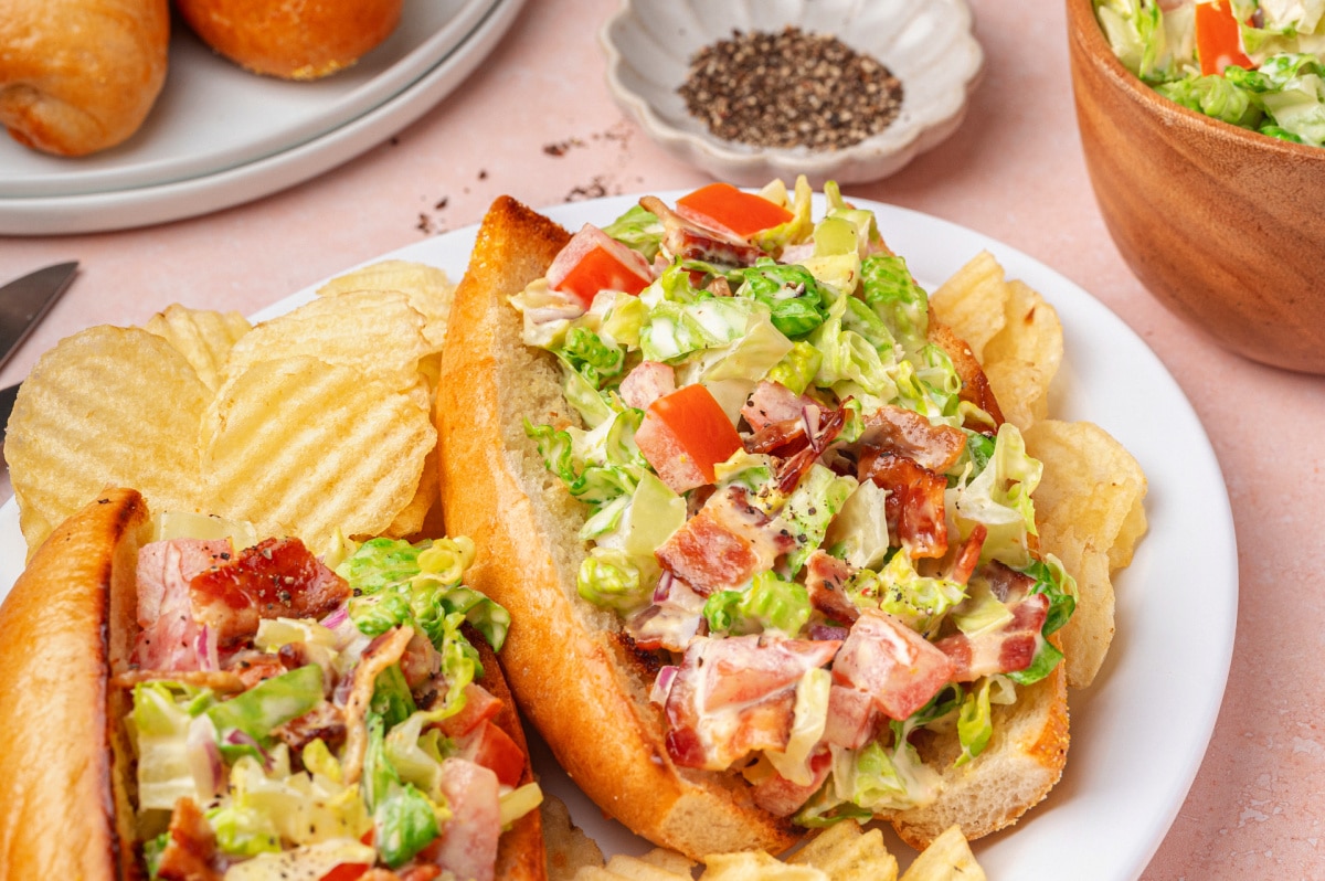 Plated chopped BLT hoagie sandwiches Two chopped BLT hoagies plated and ready to serve with toasted rolls and creamy bacon filling