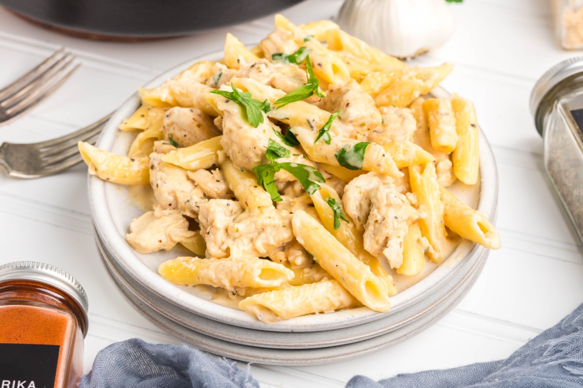 Serving of creamy garlic chicken pasta on a white plate