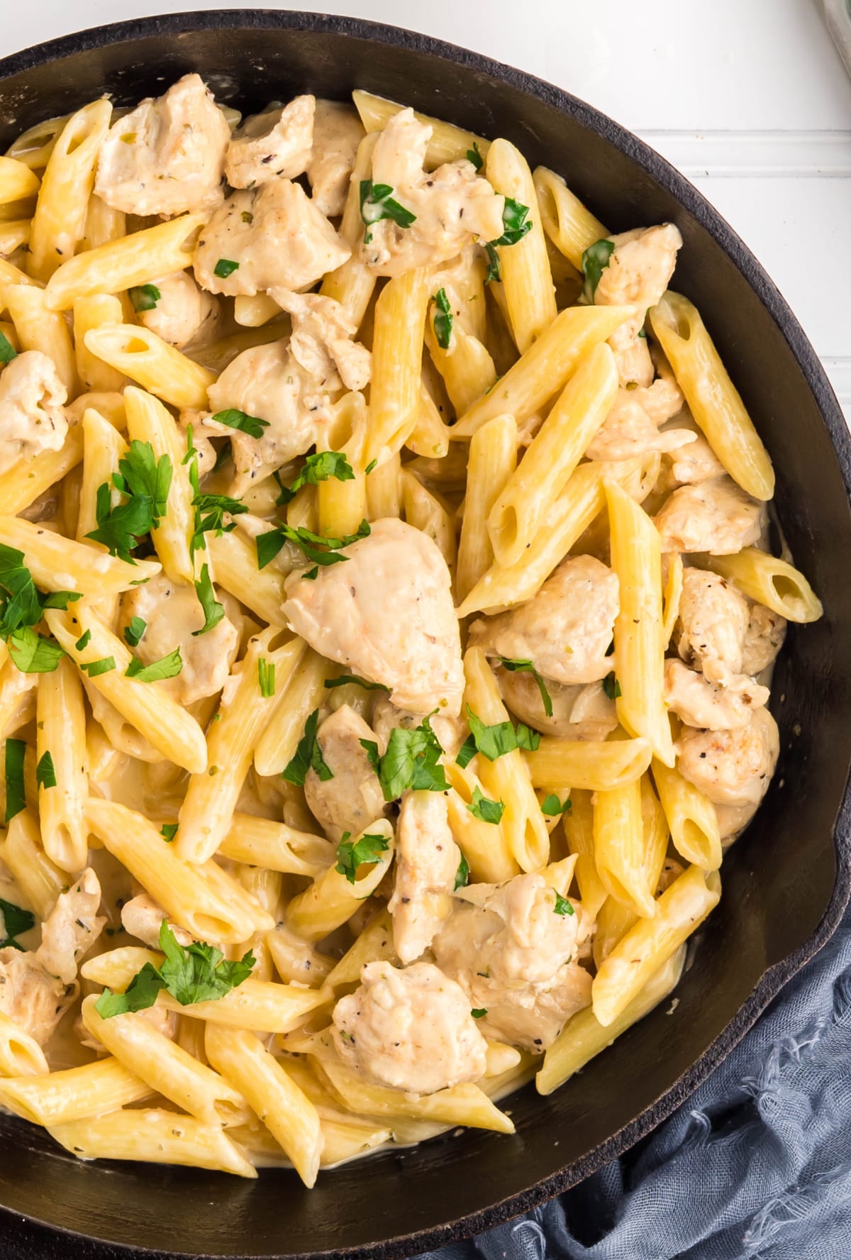Finished creamy garlic chicken pasta in a cast iron skillet