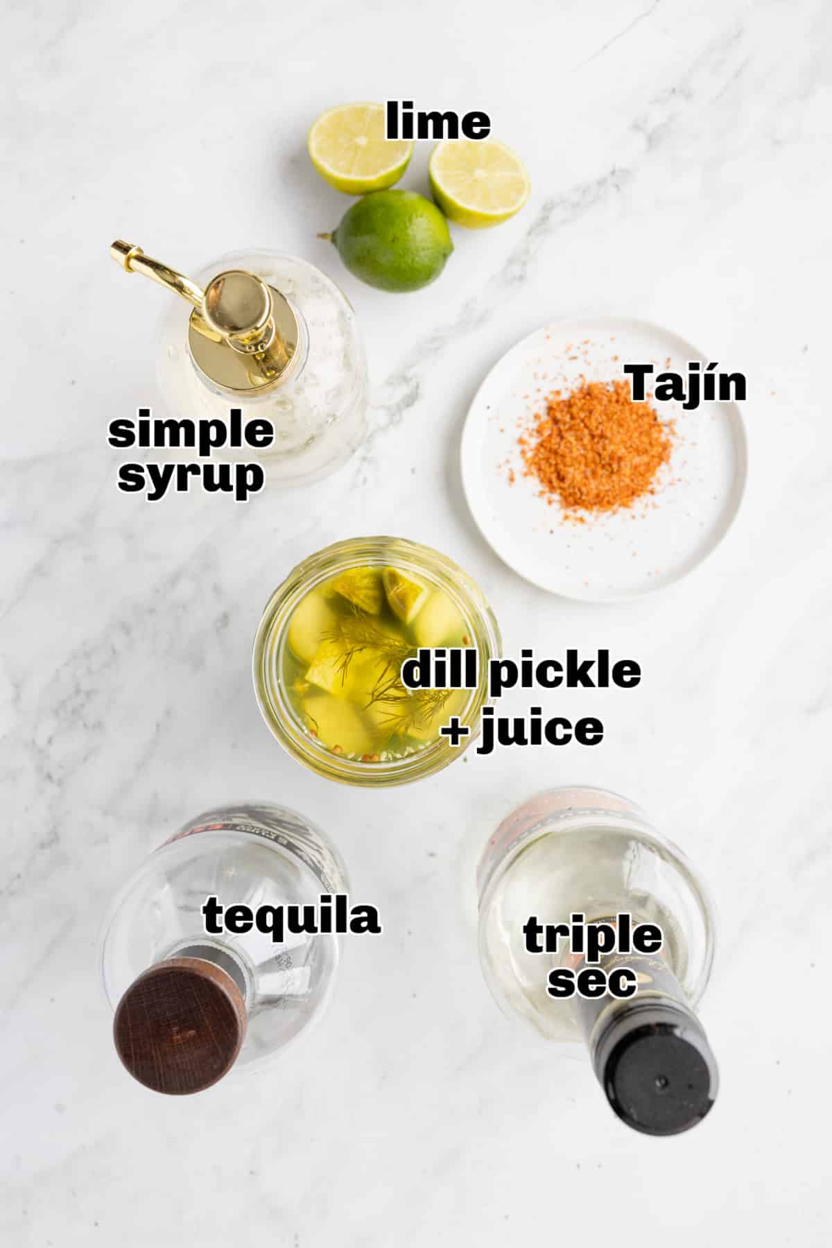 All ingredients for a dill pickle margarita arranged on a table 