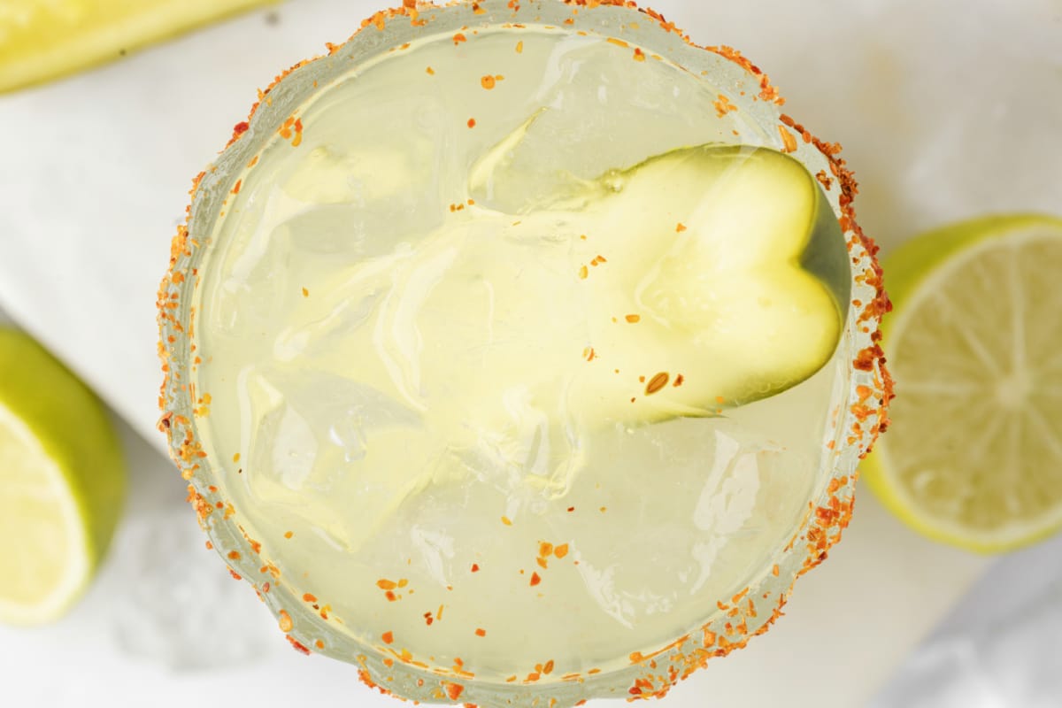 Overhead shot of dill pickle margarita garnished with a pickle spear