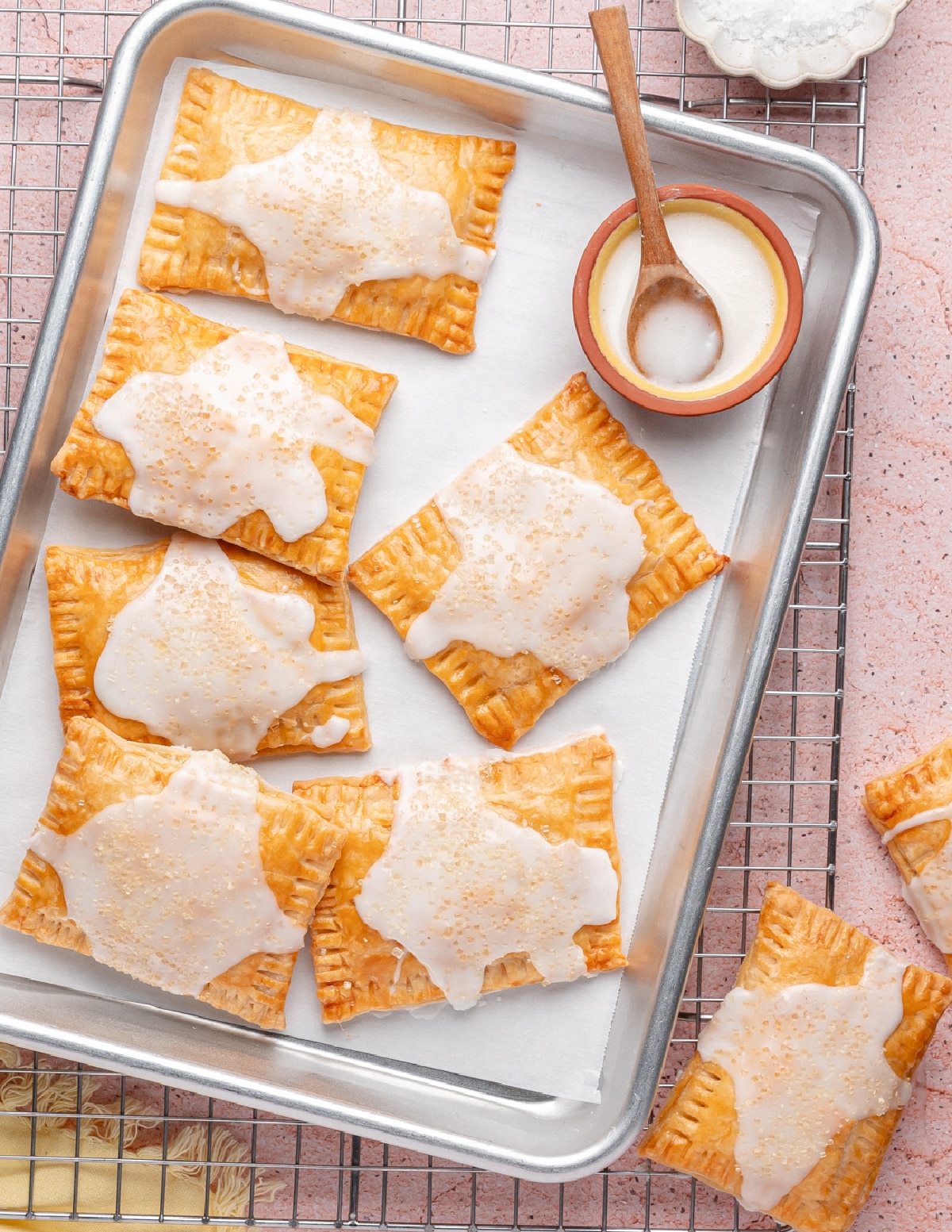 Freshly baked lemon pop tarts with glaze Lemon pop tarts with glaze on a parchment-lined tray, ready to serve