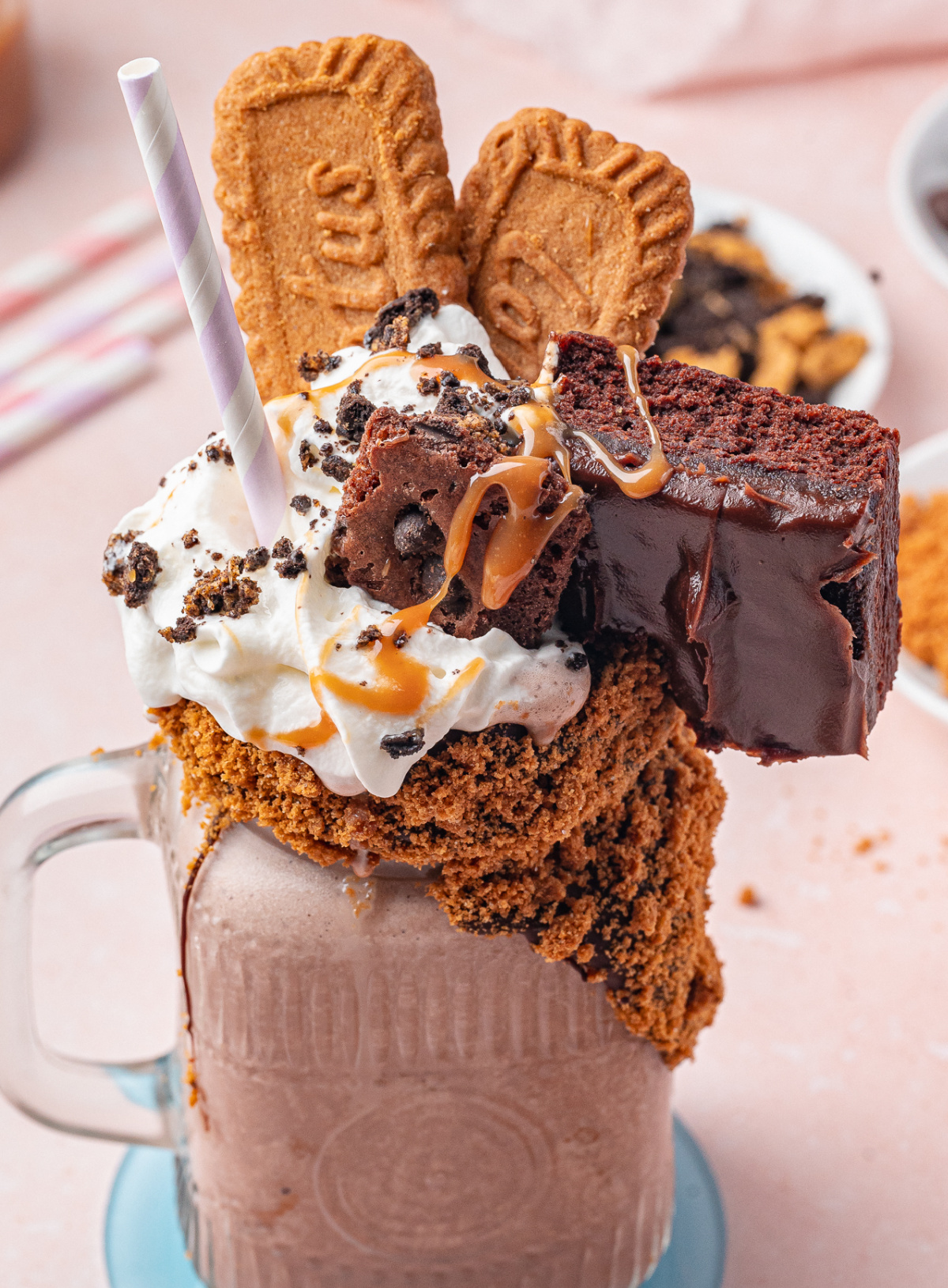 Over-the-top chocolate freakshake with Biscoff cookie rim and brownie topping Chocolate freakshake topped with brownies, Biscoff cookies, whipped cream, and caramel drizzle and toffee crunch