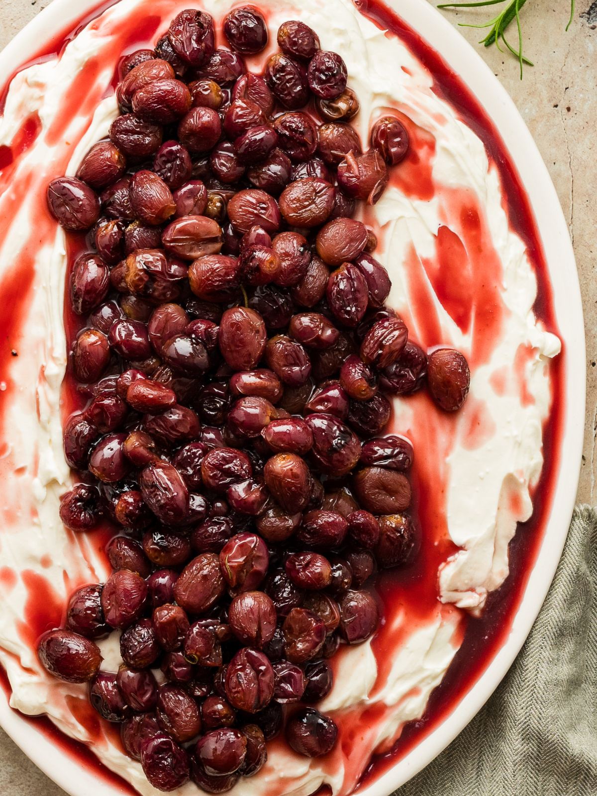 roasted grapes and whipped ricotta appetizer with balsamic glaze roasted grapes on whipped ricotta with balsamic juices in a shallow serving dish
