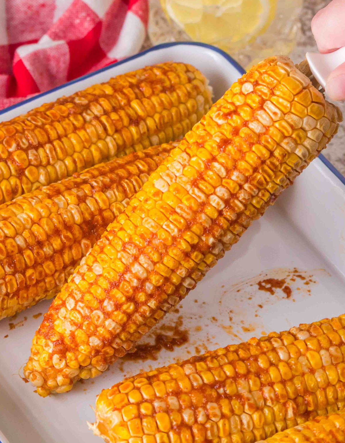  Freshly smoked corn on the cob with brown sugar garlic butter on white tray