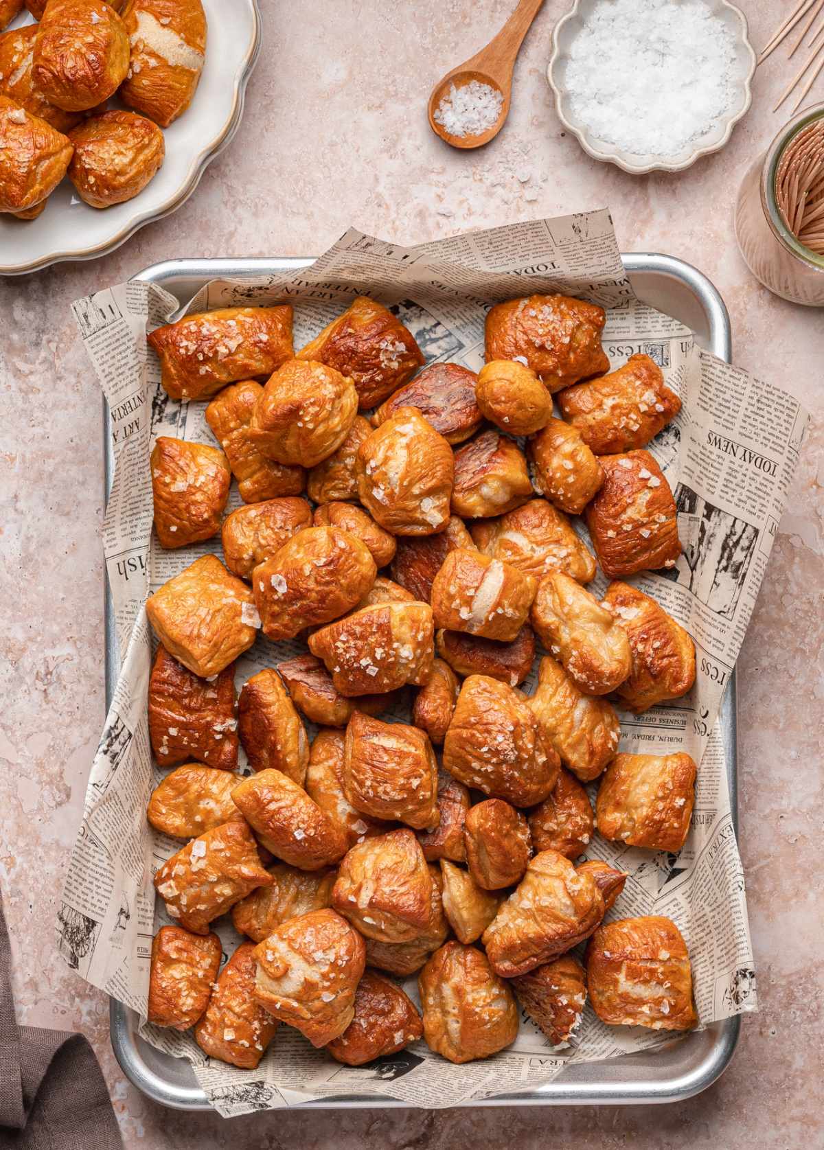 Baked Pretzel Bites straight from the oven with flaky sea salt pretzel bites fresh out of the oven on a baking tray sprinkled with flaky salt