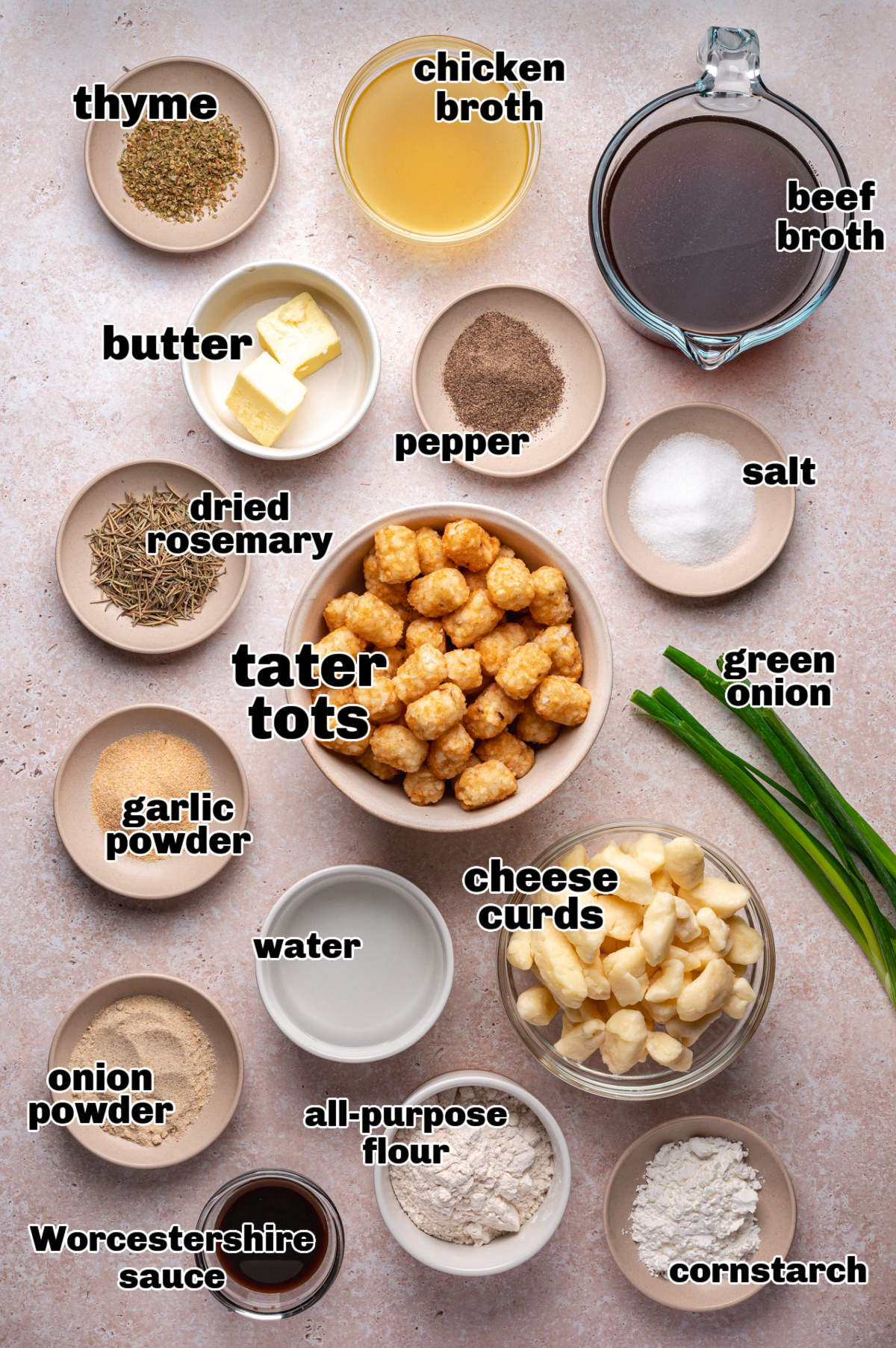 Ingredients for Easy Homemade Tater Tot Poutine Ingredients for tater tot poutine including cheese curds, beef broth, chicken broth, butter, seasonings, and tater tots.