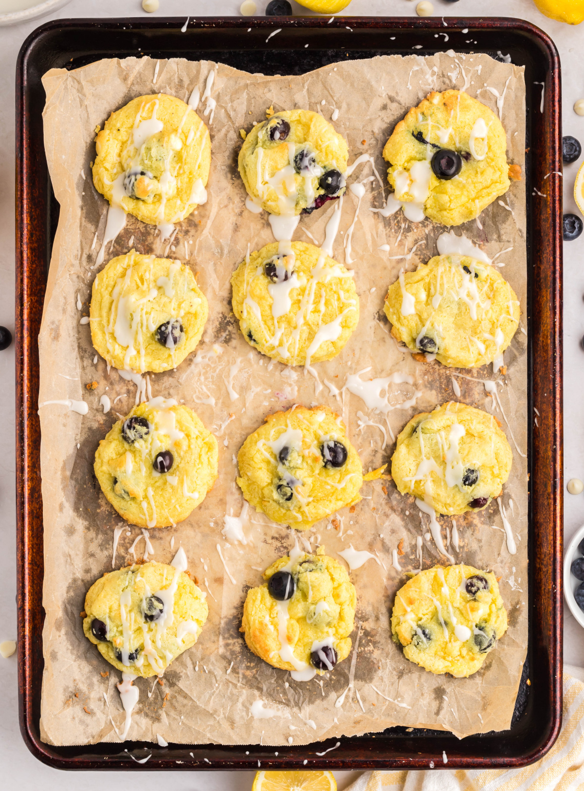 Lemon Blueberry Cake Mix Cookies Baked on Pan Full tray of lemon cake mix cookies with blueberries and glaze after baking