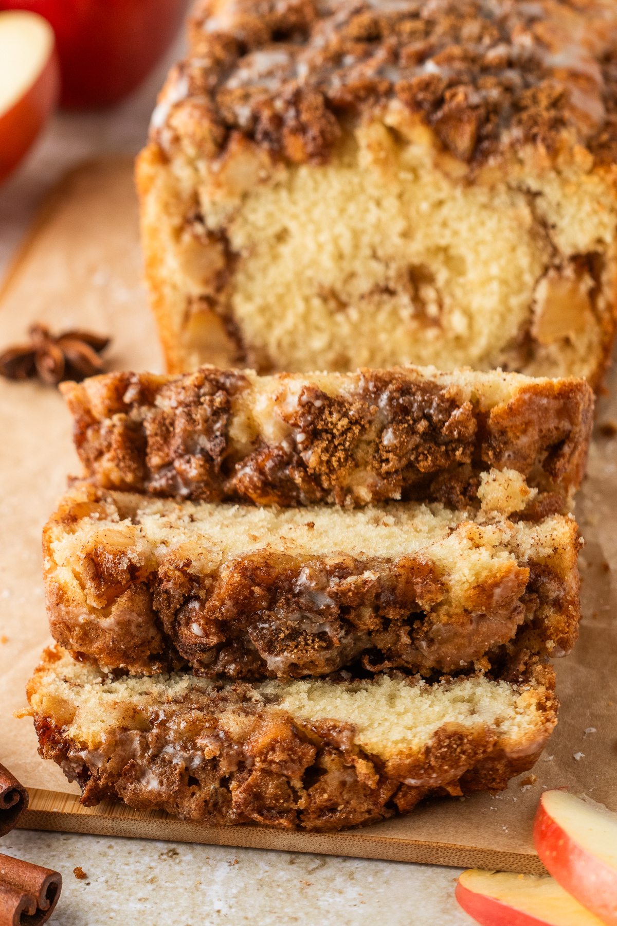 Old-fashioned apple fritter bread cut into slices with cinnamon sugar topping and glaze.