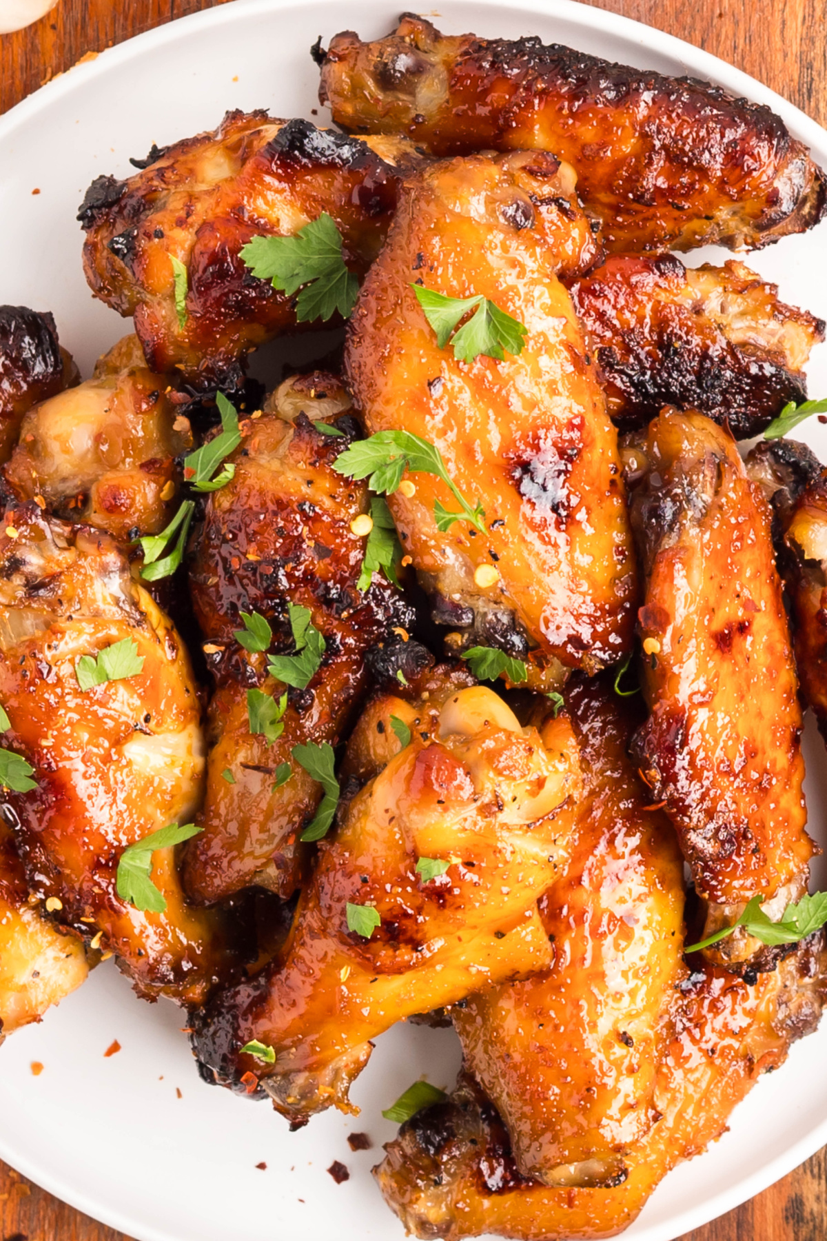 Sticky honey garlic wings ready to serve. Sticky honey garlic wings baked until golden with parsley sprinkled on top.