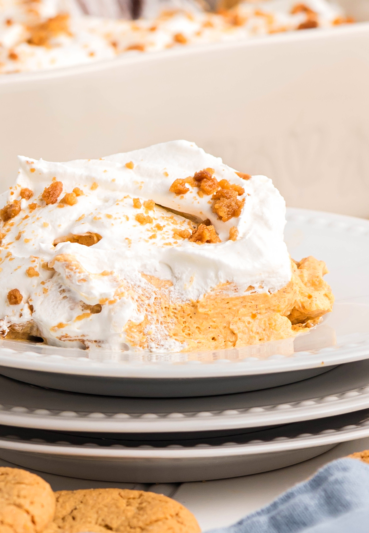 Cold pumpkin dessert slice with creamy layers and cookie crumbs