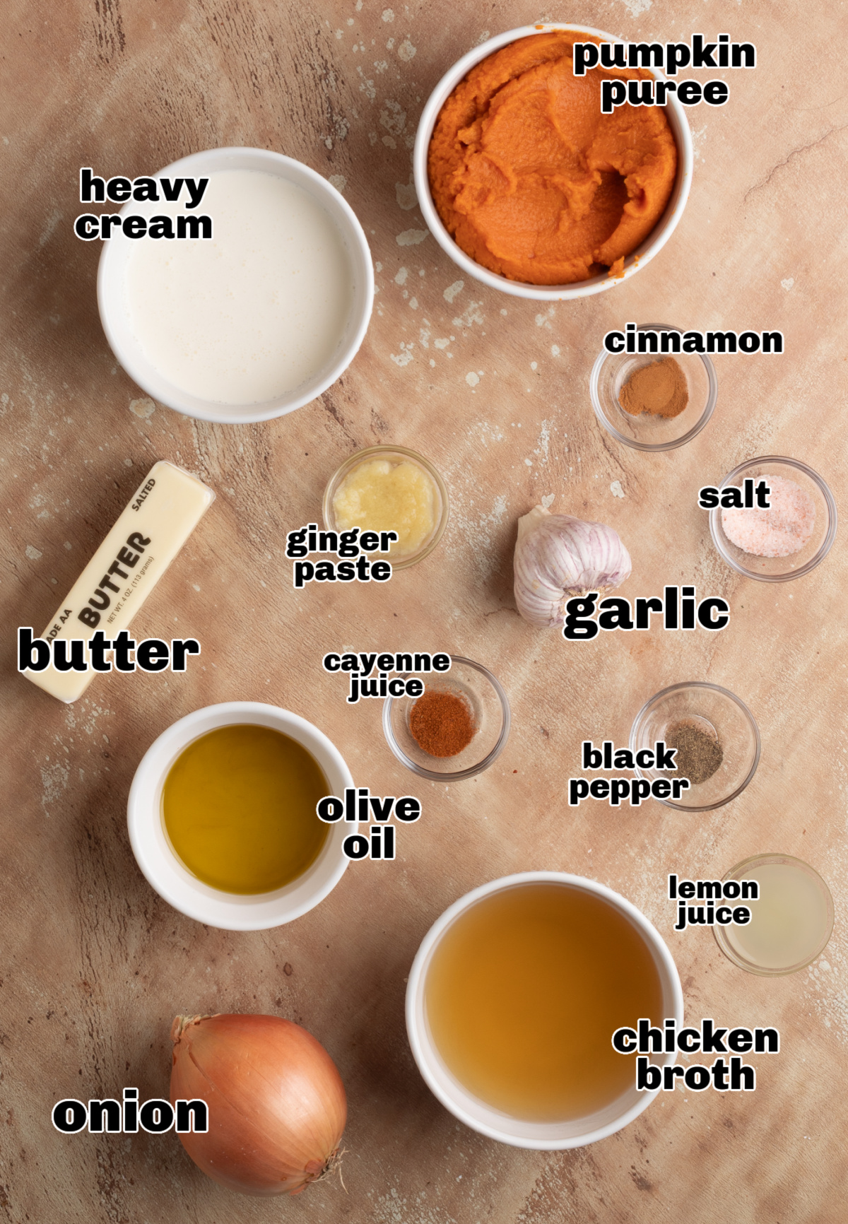pumpkin soup ingredients ingredients for roasted garlic pumpkin soup with brown butter including pumpkin purée, garlic, cream, onion, and spices on a table