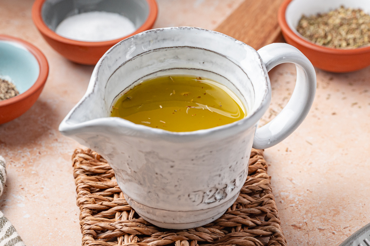 Homemade White Balsamic Vinaigrette White balsamic vinaigrette in a ceramic pitcher ready to serve