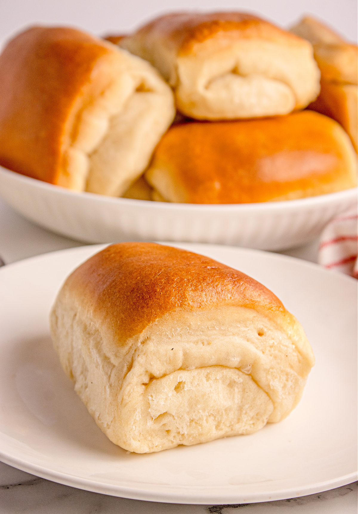 Parker House Roll on a plate highlighting the buttery fold and soft dinner-roll crumb.