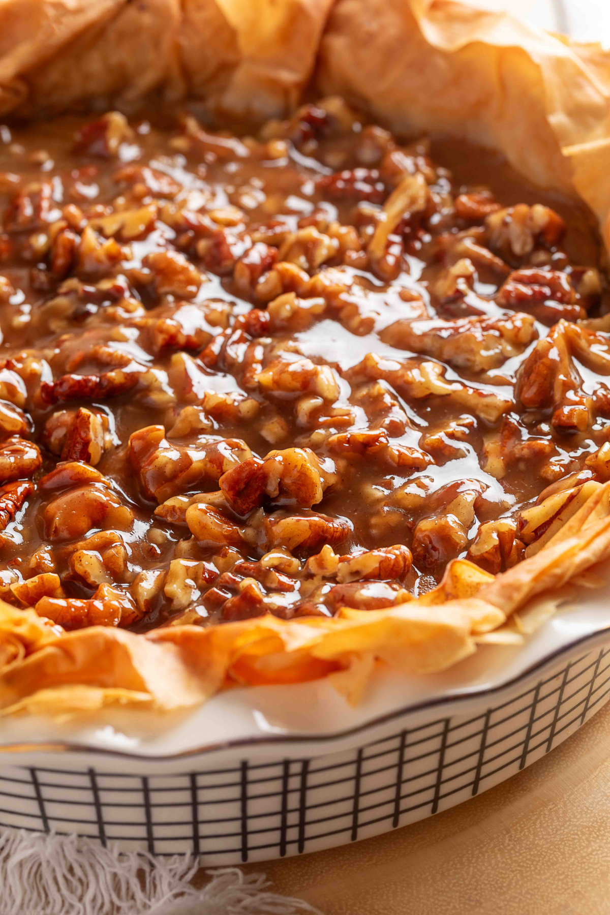 A whole pumpkin praline pie with a ruffled phyllo crust.