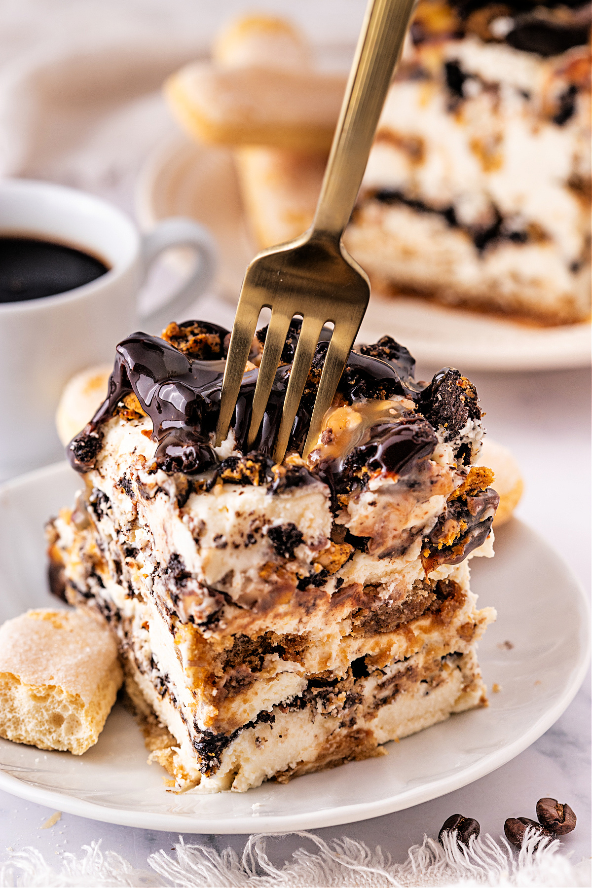 Toffee tiramisu by Noble Pig with espresso-soaked layers, mascarpone cream, caramel drizzle, and crushed Toffee Crunch OREOs.