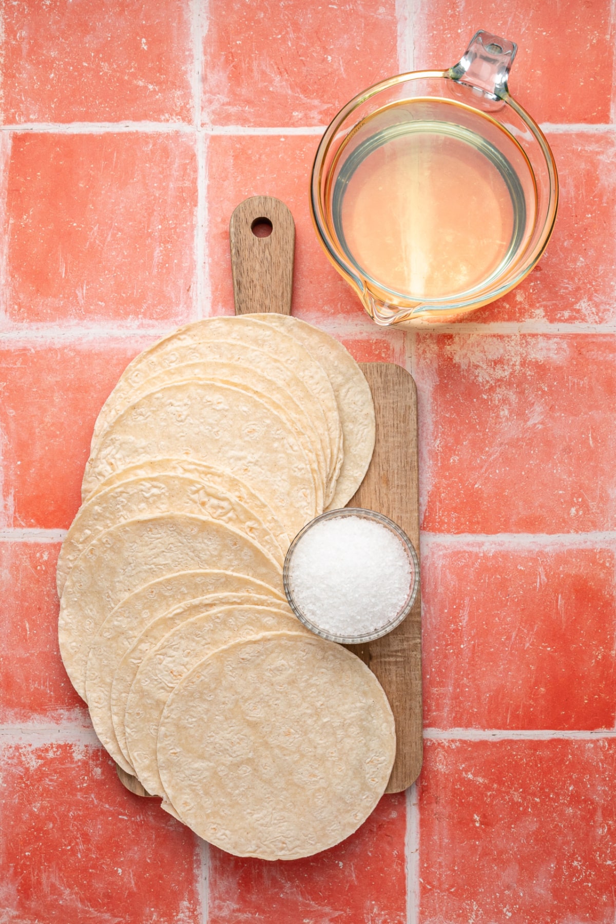 Ingredients used to make homemade fried tortilla chips with white corn tortilla, oil and salt. ingredients for homemade fried tortilla chips recipe