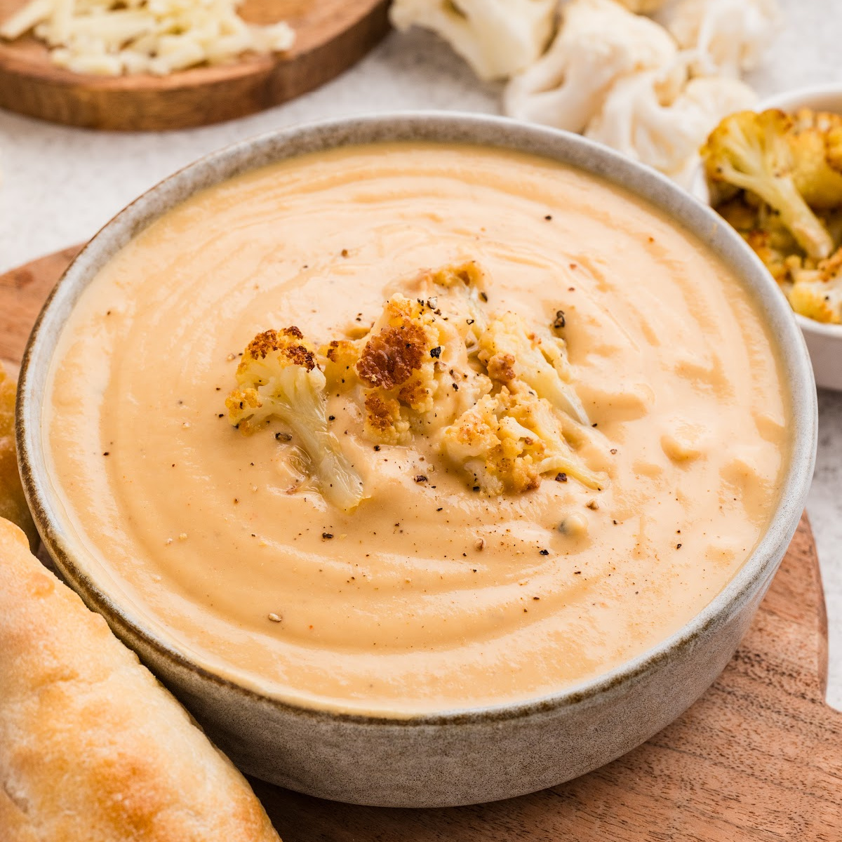 Roasted Cauliflower Soup made with caramelized cauliflower florets and roasted garlic, blended smooth and finished with a creamy texture.