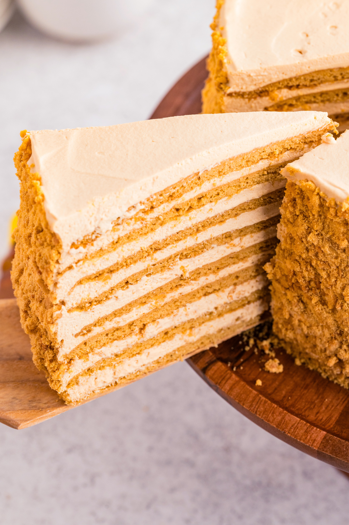 A sliced Russian honey cake (Medovik) showing thin honey cake layers softened with dulce de leche cream.