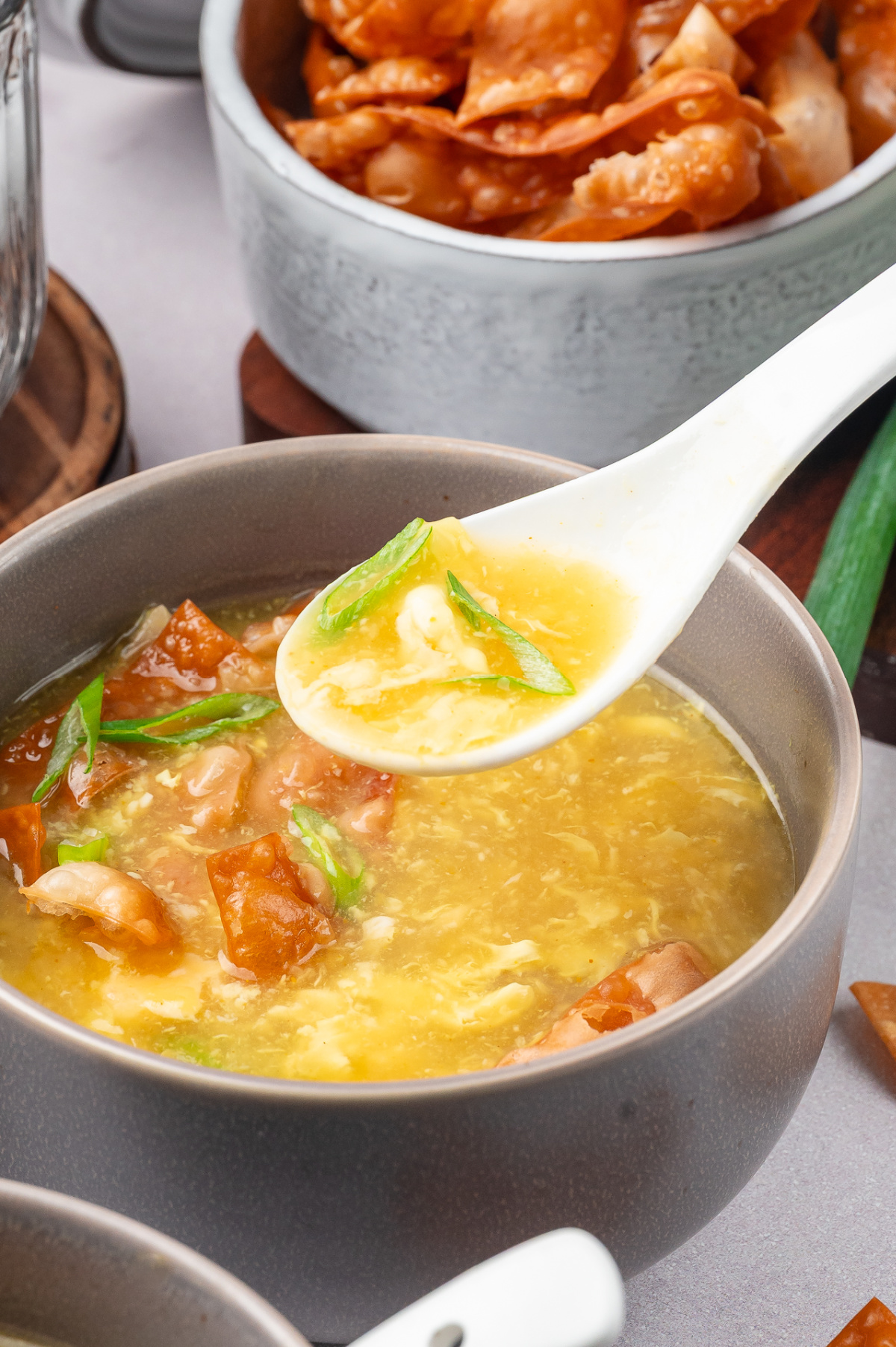 silky egg drop soup with fried wonton strips and delicate egg ribbons