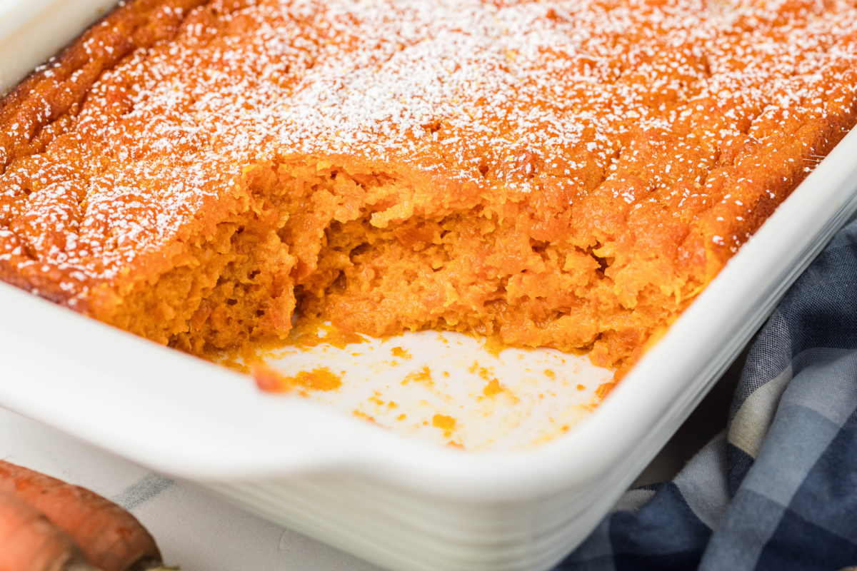 Carrot Souffle with spooned-out portion in baking dish Close-up of Carrot Souffle showing soft, custard-like center after serving