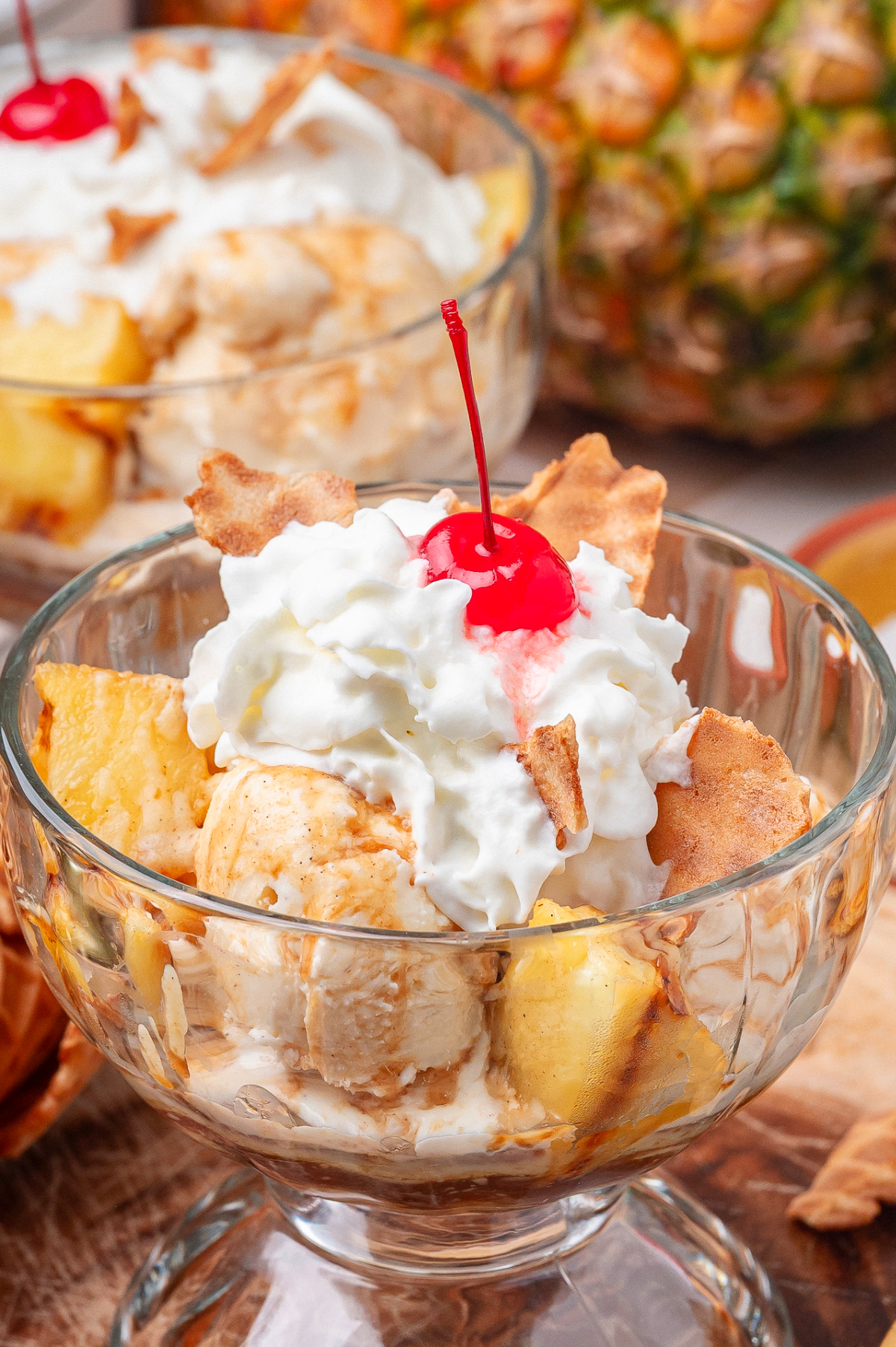Grilled Pineapple Sundae with Hot Buttered Rum Sauce Spoonful of grilled pineapple sundae with hot buttered rum sauce and melting vanilla ice cream