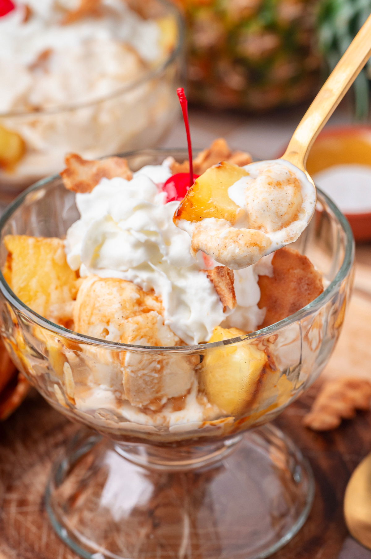 Grilled Pineapple Sundae with Hot Buttered Rum Sauce Grilled pineapple sundae with hot buttered rum sauce, vanilla ice cream, whipped cream, and a cherry on top