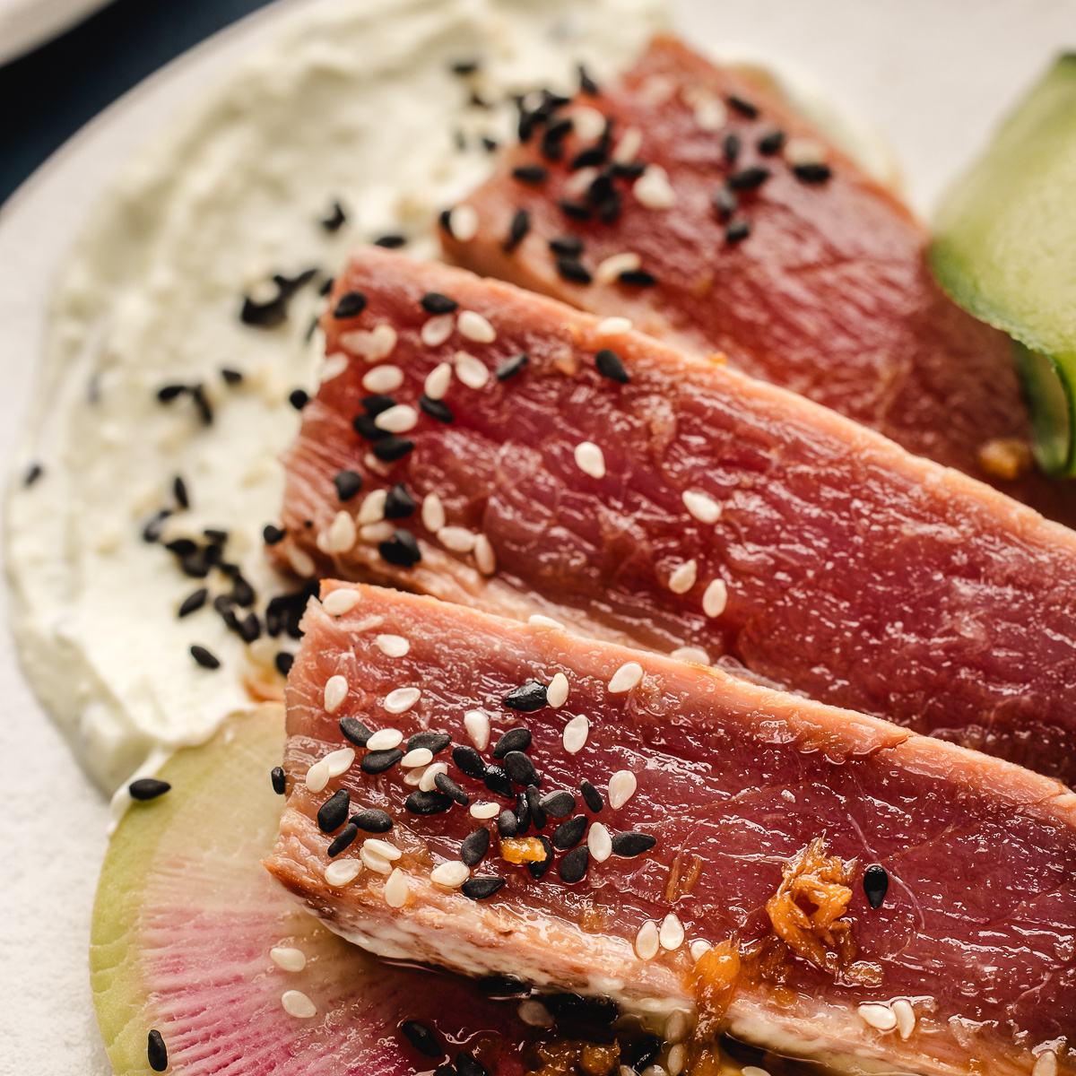 Seared ahi tuna plated with watermelon radish and wasabi yogurt