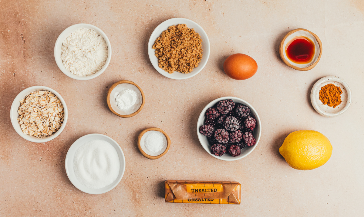 Ingredients for blackberry oat crumble bars with fresh or frozen blackberries and oats ingredients for blackberry oat crumble bars including blackberries, oats, flour, butter, sugar, and lemon