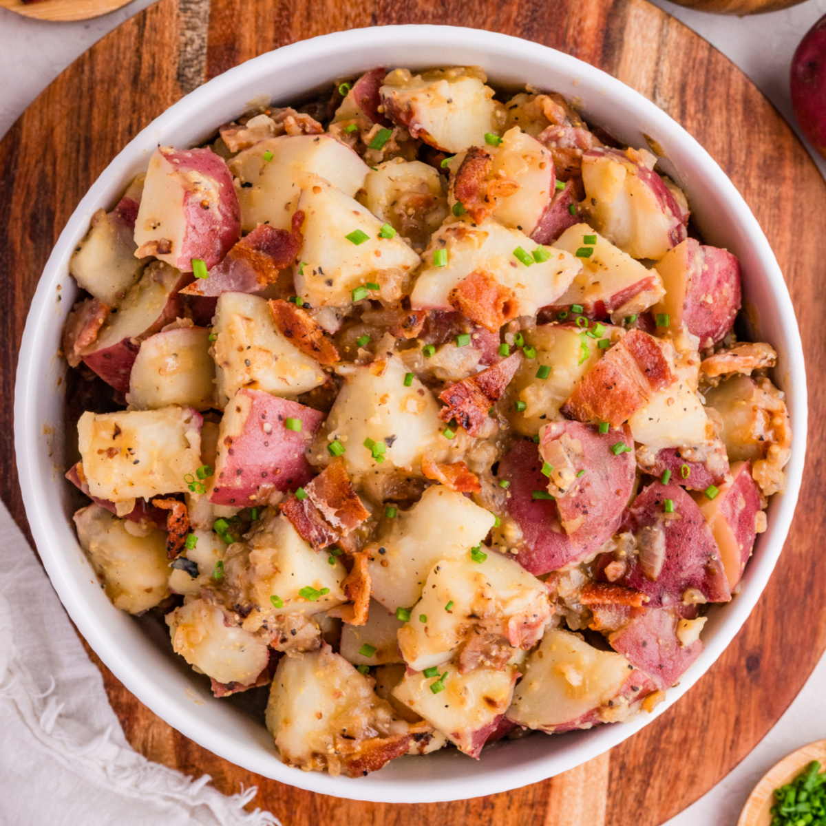 German potato salad with crispy bacon, red potatoes, and whole grain mustard dressing