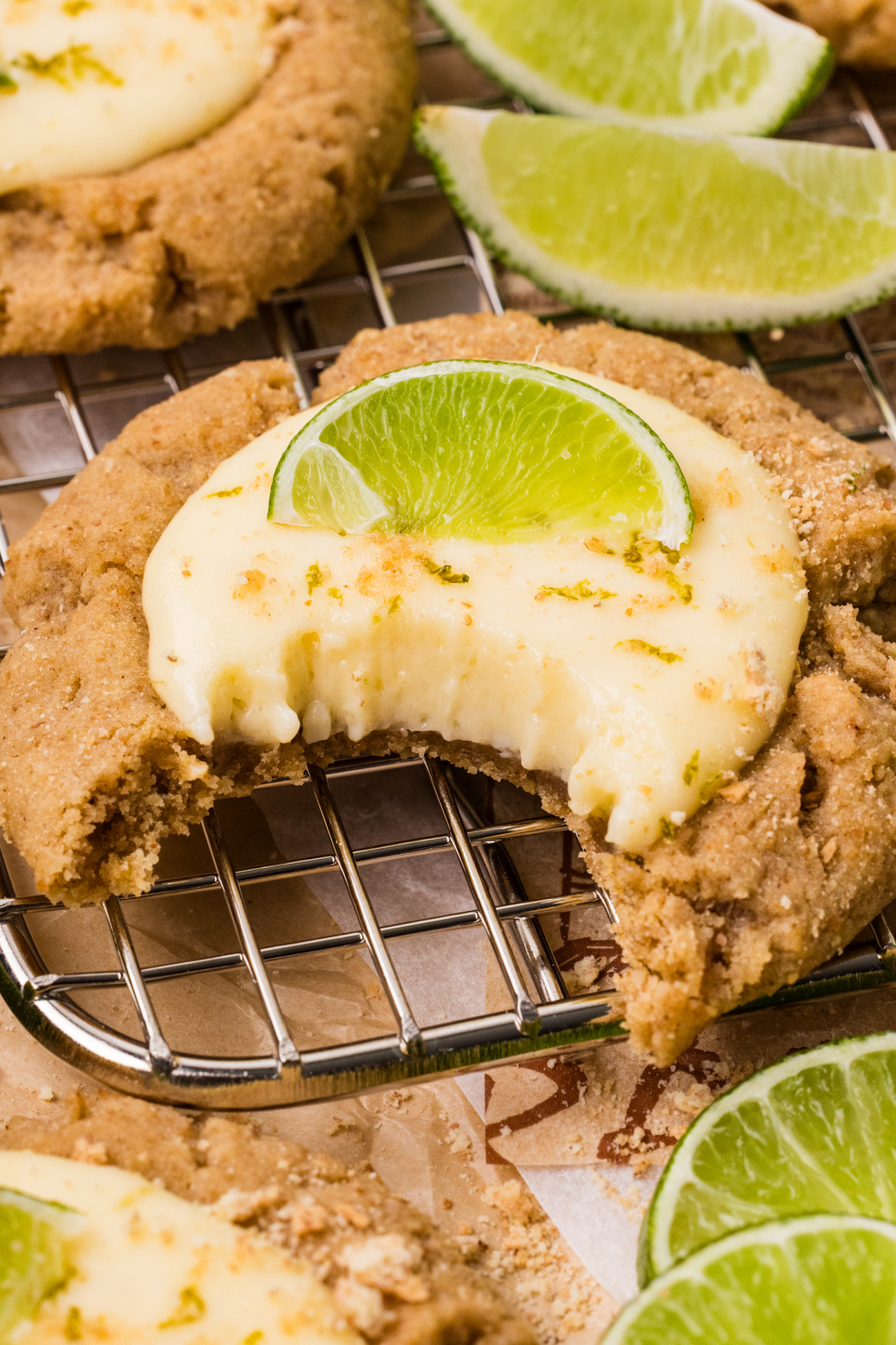 close-up bite of cookie showing creamy lime filling and crumb texture key lime pie cookies with creamy lime curd center and graham cracker cookie base close-up
