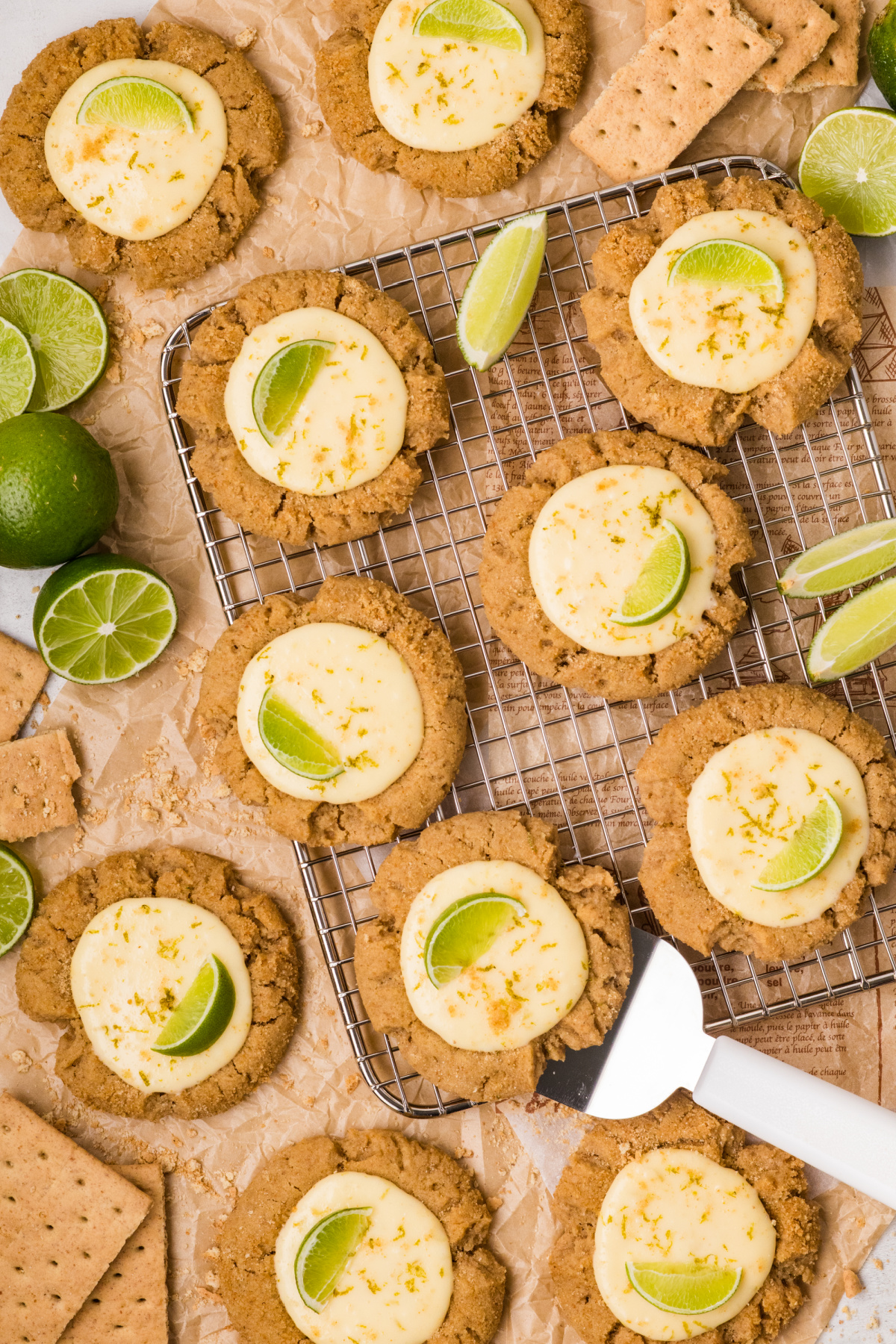key lime pie cookies cooling with graham crumb edges and lime topping key lime pie cookies on cooling rack with creamy lime centers and fresh lime slices