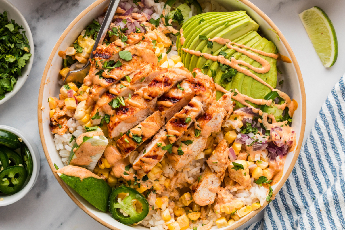 street corn chicken bowl with avocado, corn, and lime crema street corn chicken rice bowls with grilled chicken, avocado, charred corn, jalapeños, and creamy elote-style sauce