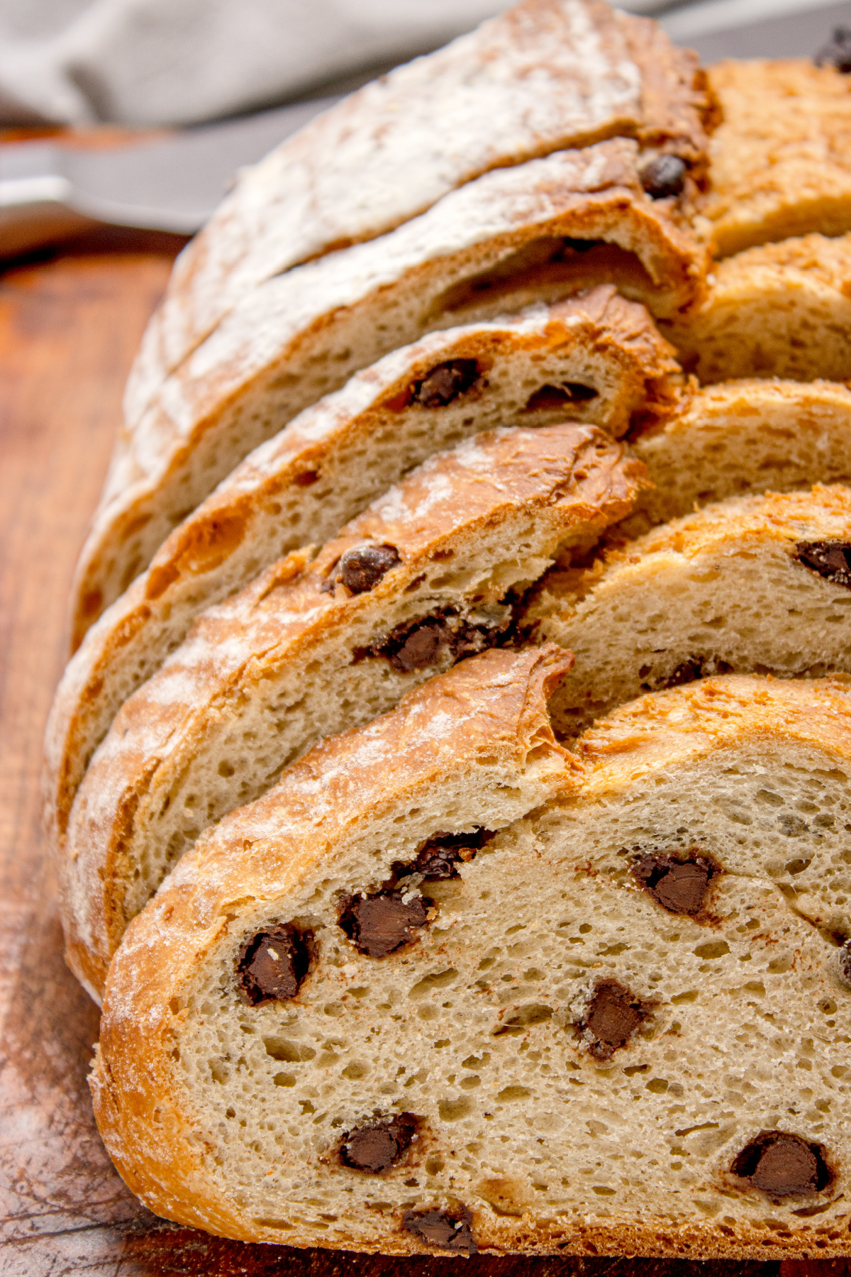 close view of the interior with chocolate pieces throughout the slices close-up of sliced chocolate chip bread showing airy crumb and chocolate pieces inside