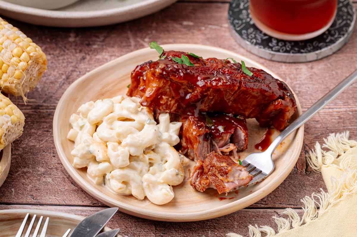 Bourbon peach country style ribs with peach barbecue glaze served with macaroni salad