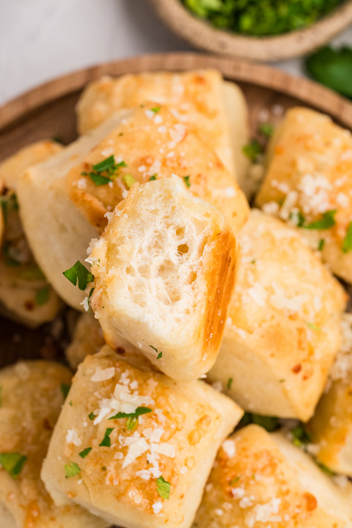 Parmesan bread bite showing the soft, fluffy interior and golden Parmesan crust