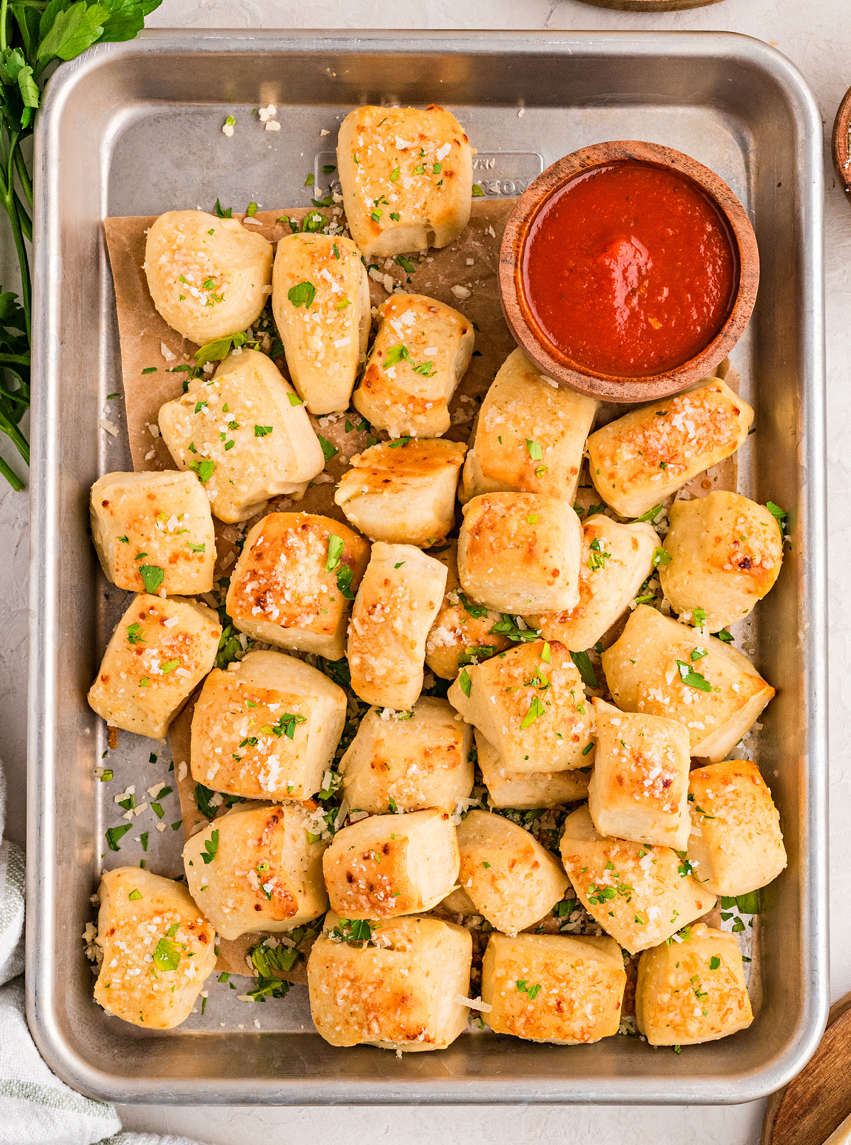 Parmesan bread bites baked until golden brown and served with marinara sauce for dipping
