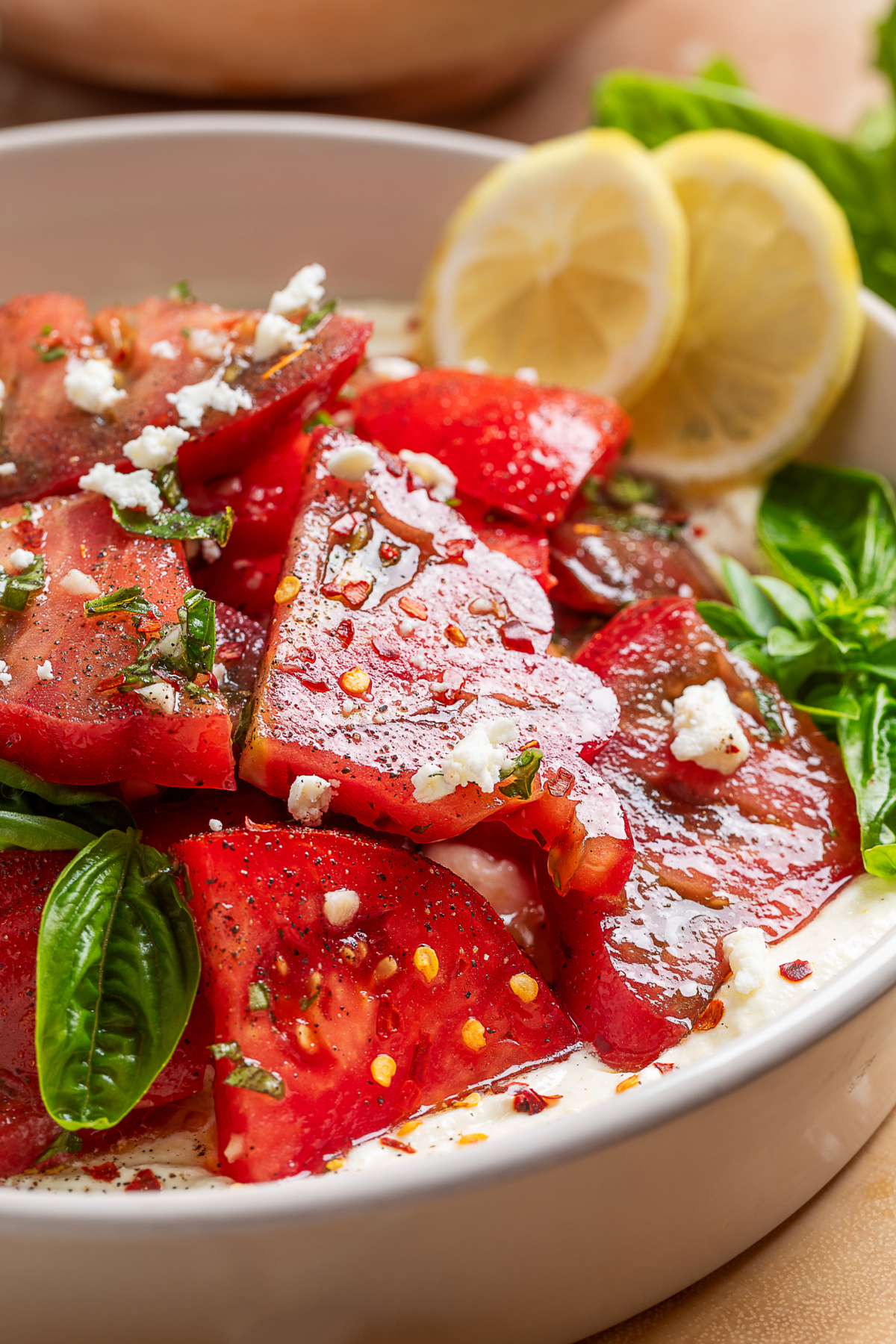 Heirloom tomato salad over whipped ricotta feta with fresh basil, lemon, and a simple vinaigrette.