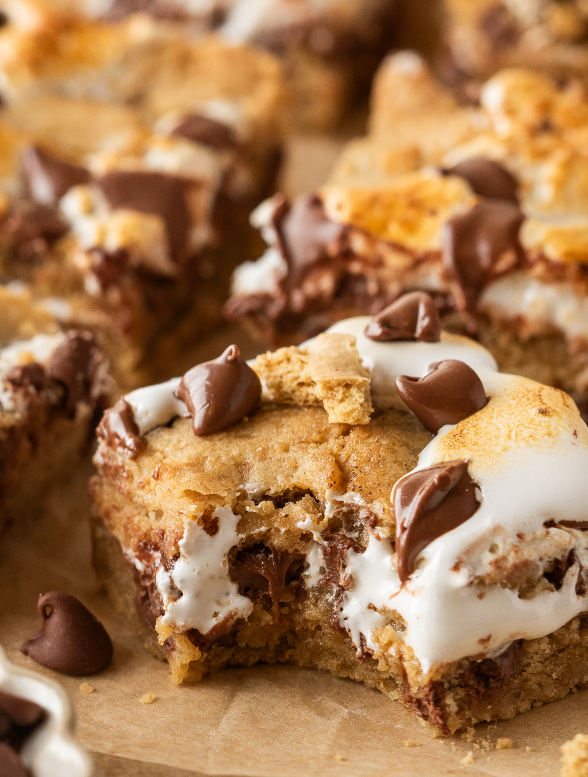 Gooey Center S'mores Cookie Bars S'mores cookie bars with graham cookie dough, gooey marshmallow creme, and milk chocolate chips.