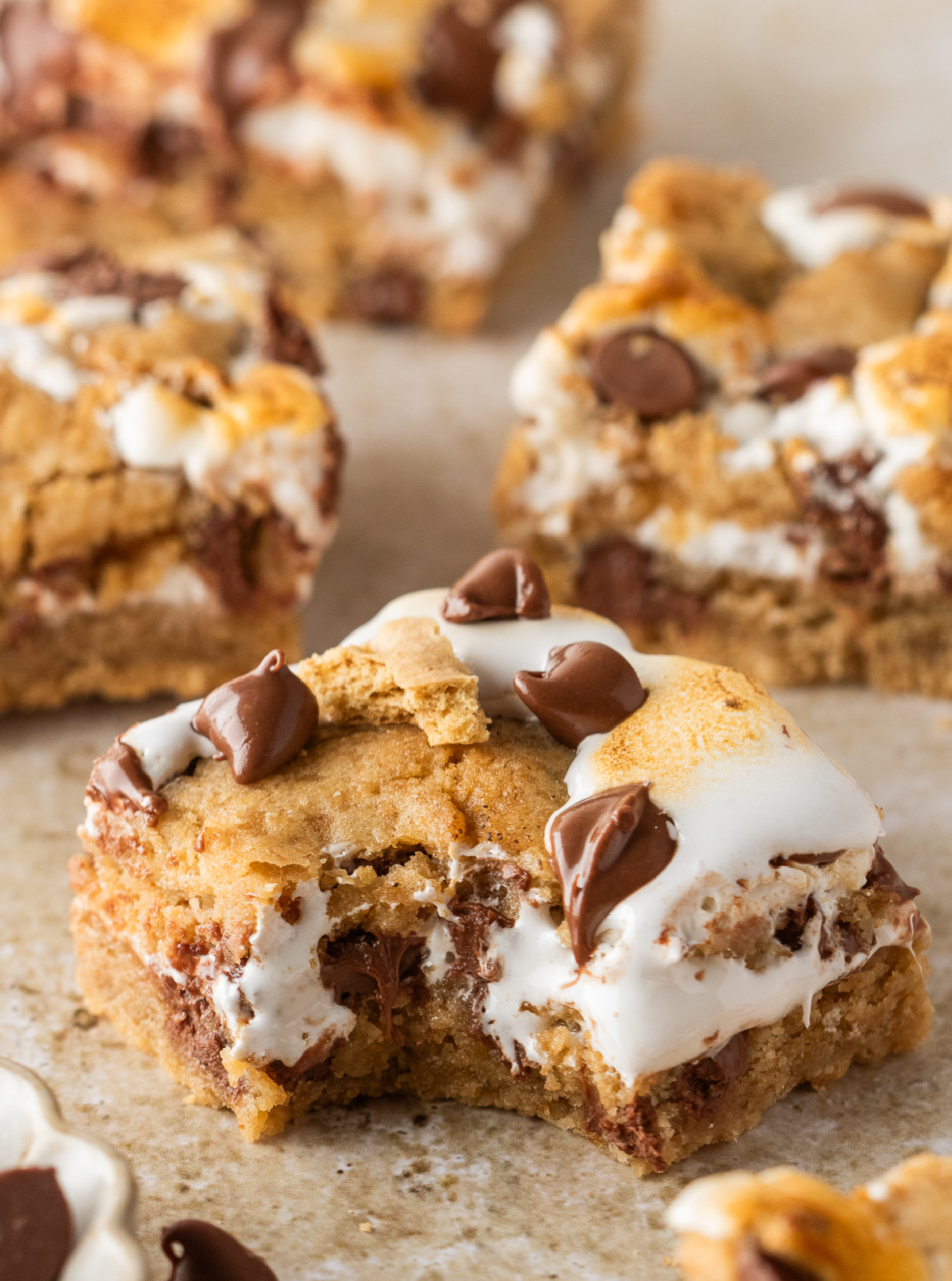 S'mores Cookie Bars Close-up of s'mores cookie bars showing the gooey marshmallow creme center and milk chocolate inside the graham cookie dough.