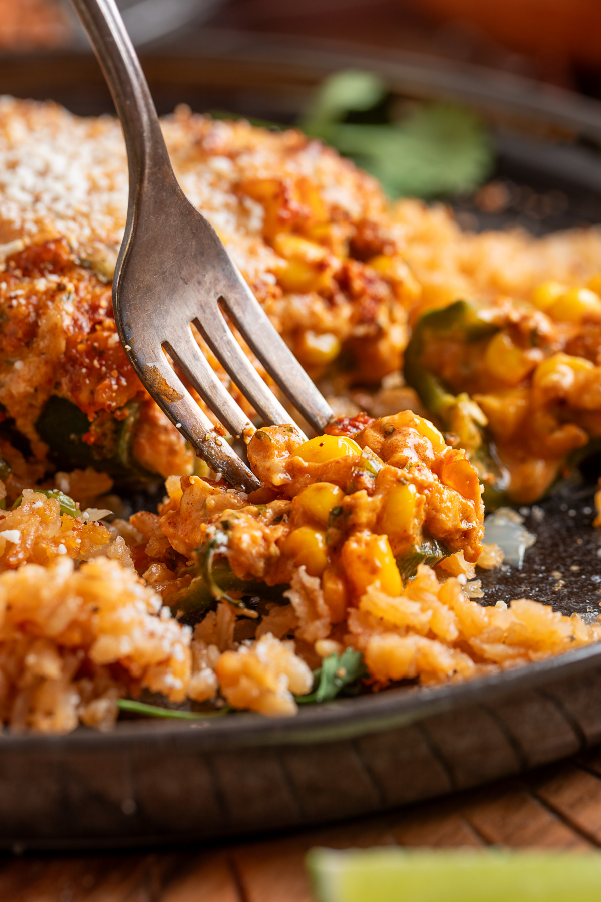Stuffed poblano pepper cut open with creamy chorizo, corn, jalapeño and cheese filling served over rice