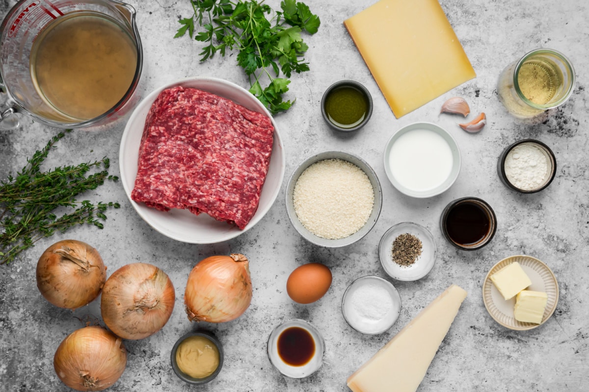Ingredients for French onion meatballs including ground beef, yellow onions, Gruyère, Parmesan, panko, white wine and beef broth